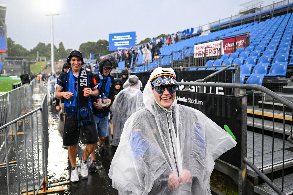 Fans leave the stands after the match is paused due to extreme weather conditions. Photo / Photosport