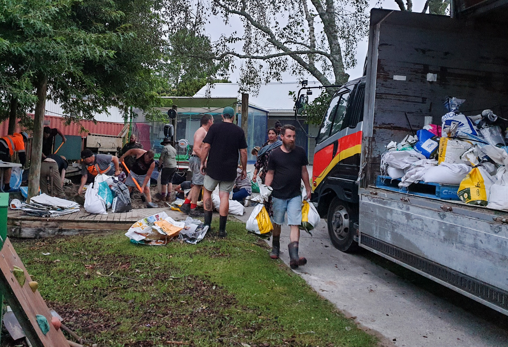 Volunteers make up sandbags from the sandpit at the Kumeu playcentre west Auckland in anticipation of fresh flooding as heavy rain is predicted to hit Auckland. Photo / Supplied