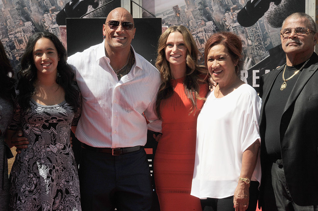 Dwayne's eldest daughter, Simone Alexandra Johnson, stands alongside him, his wife Lauren Hashian, mother Ata Johnson and father Rocky Johnson. Photo / Getty Images