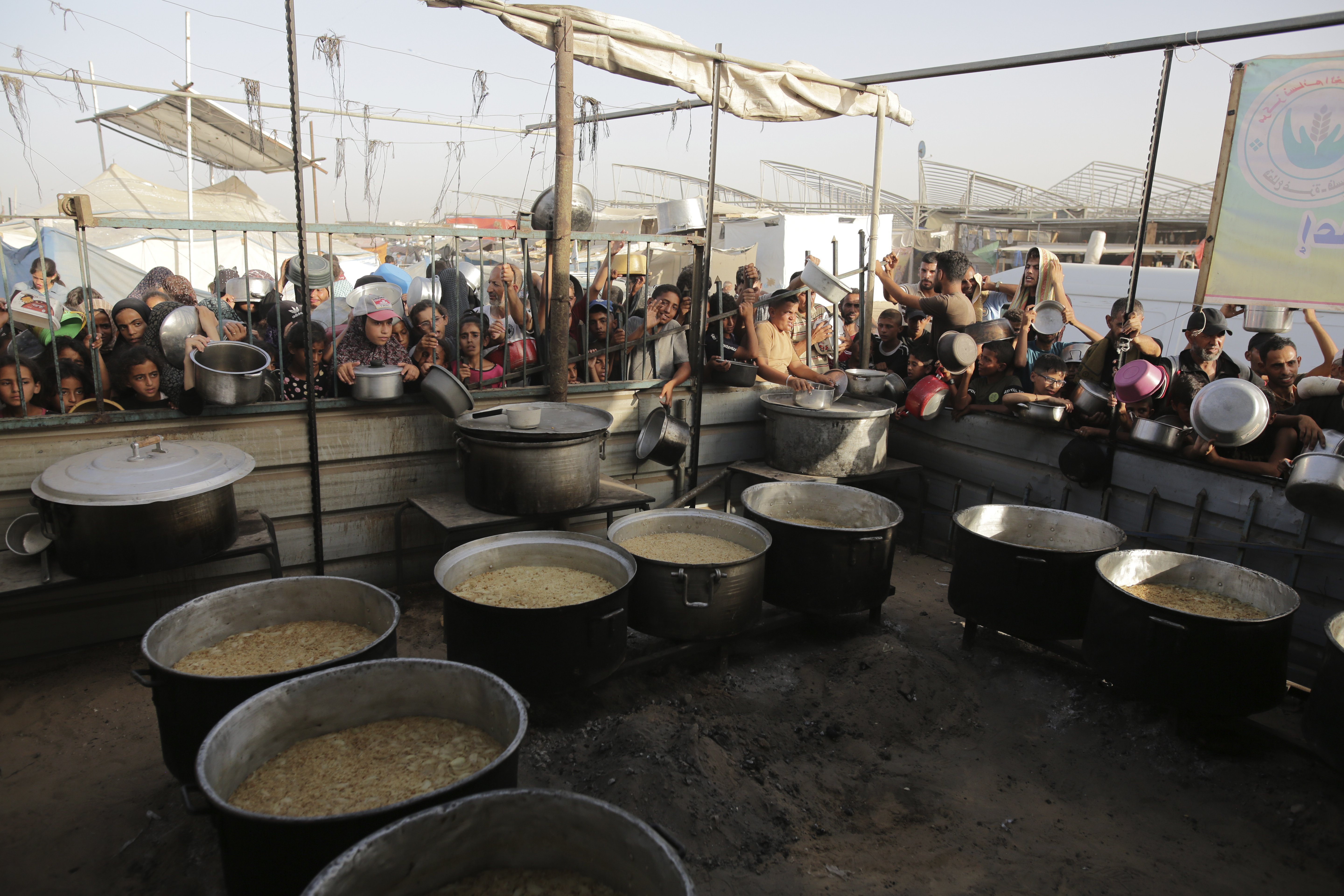 Palestinians collect food aid ahead of the upcoming Eid al-Adha holiday in Jerusalem. Photo / AP