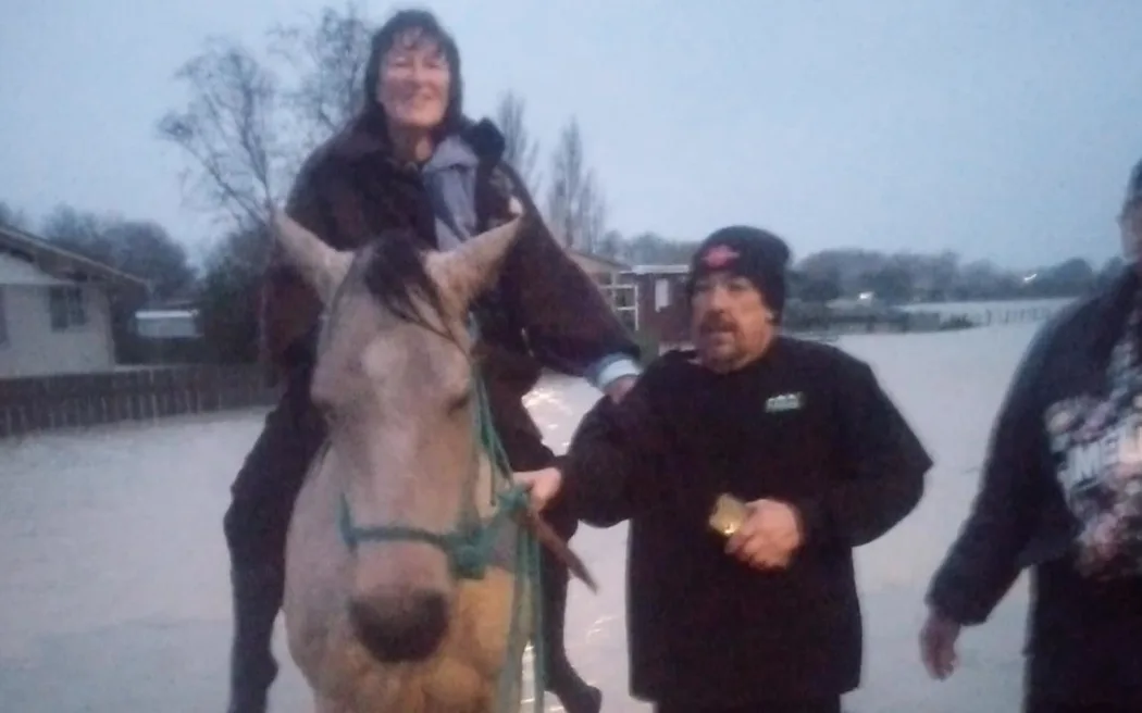 Irelle Lowe being rescued on the back of the local vet's horse. Photo / Supplied