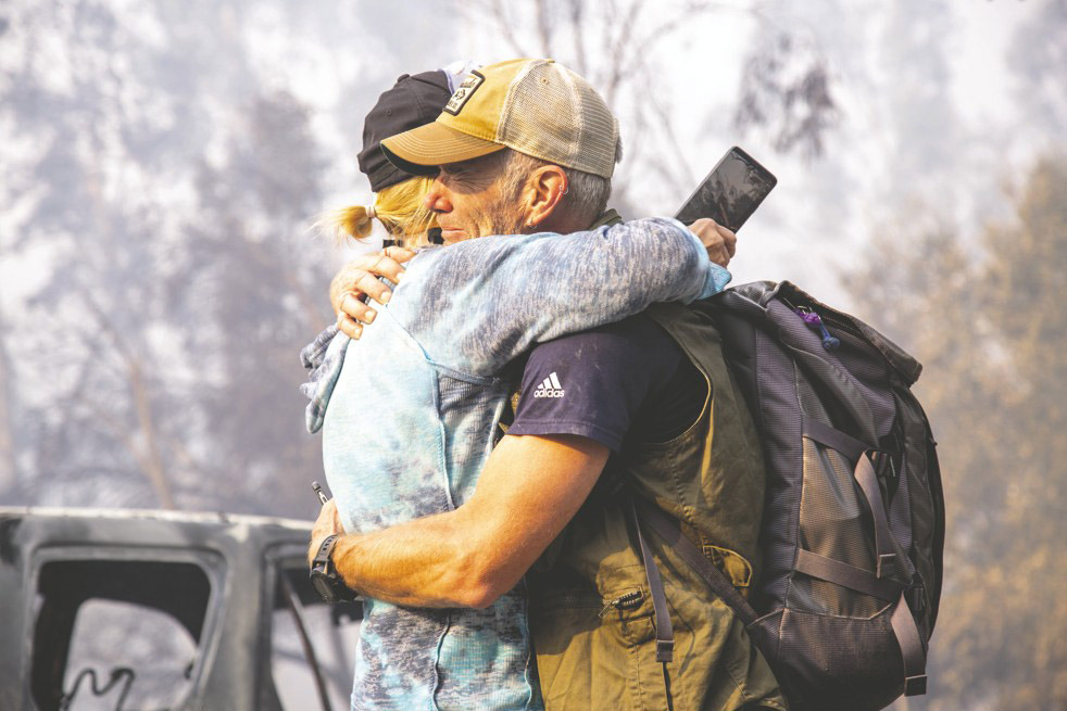 Jeff McClenahan hugs neighbour Sharon Woods after seeing his destroyed home for the first time in Agora Hills. Photo / Washington Post