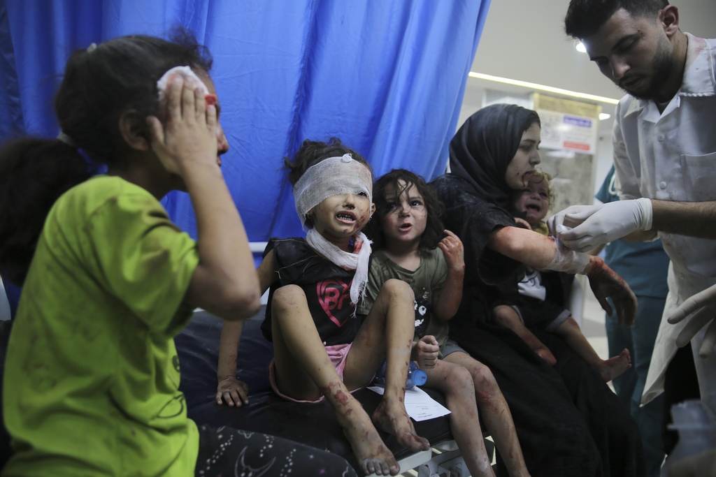 Palestinian children wounded in Israeli strikes are brought to Shifa Hospital in Gaza City on Wednesday, October 11. (AP Photo/Ali Mahmoud)