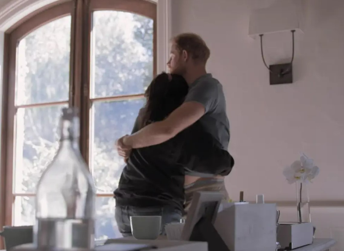 Meghan gives Harry a hug after he received the text. Photo / Netflix
