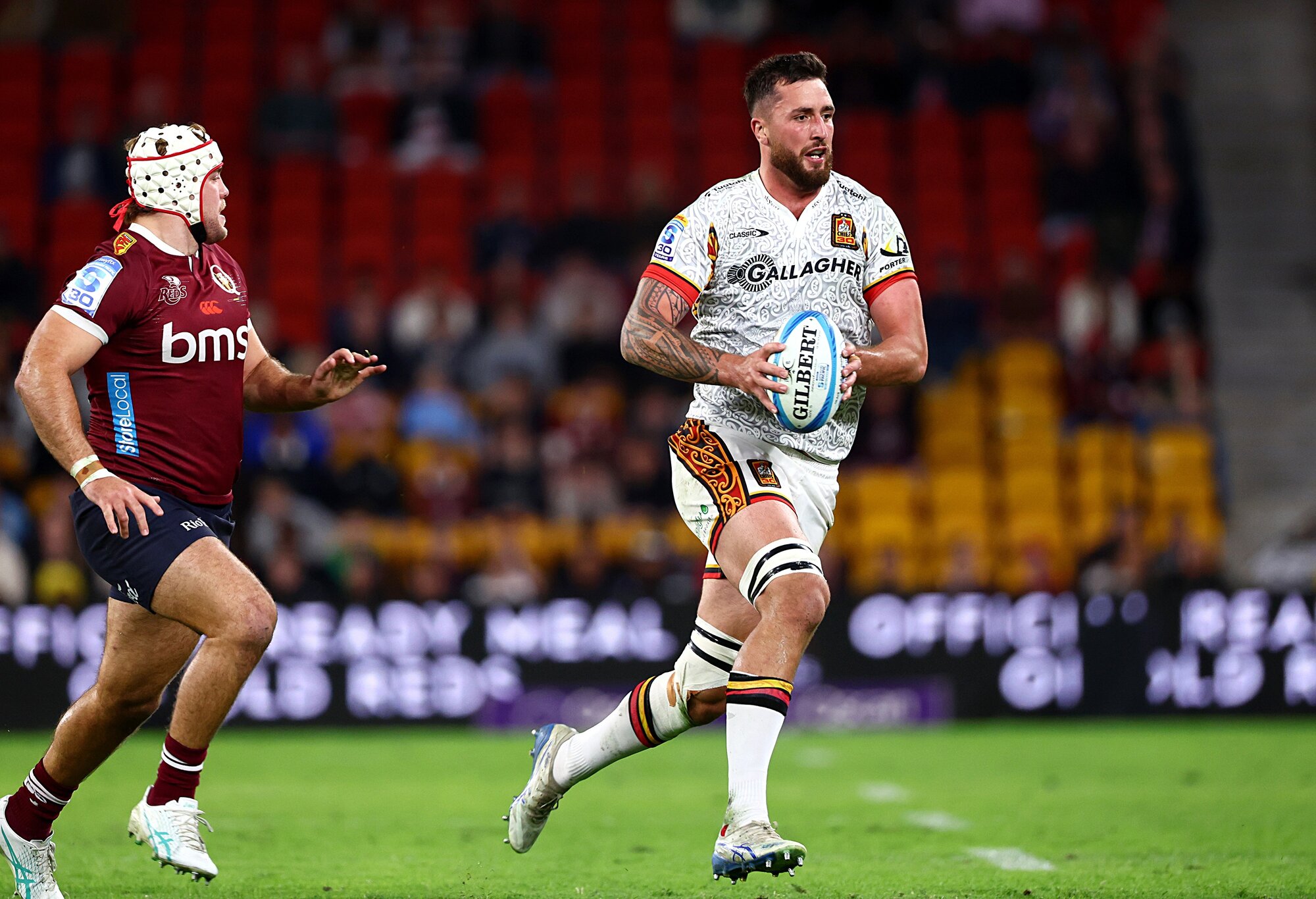 Josh Lord makes a break for the Chiefs against the Reds. Photo / Photosport