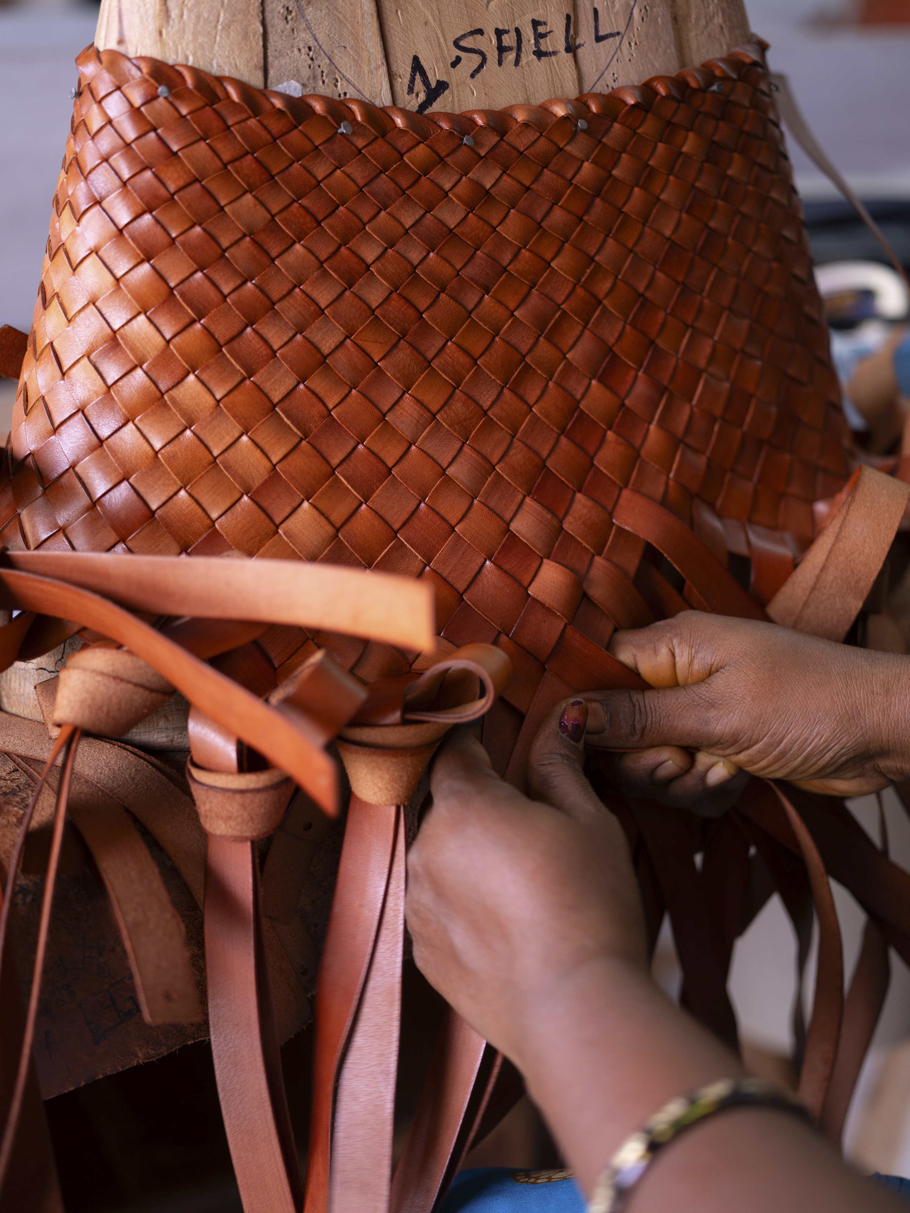 A bag being woven on one of the wooden lasts created for the factory by a pair of carpenters. Photo / Priyadarshini Ravichandran, The New York Times