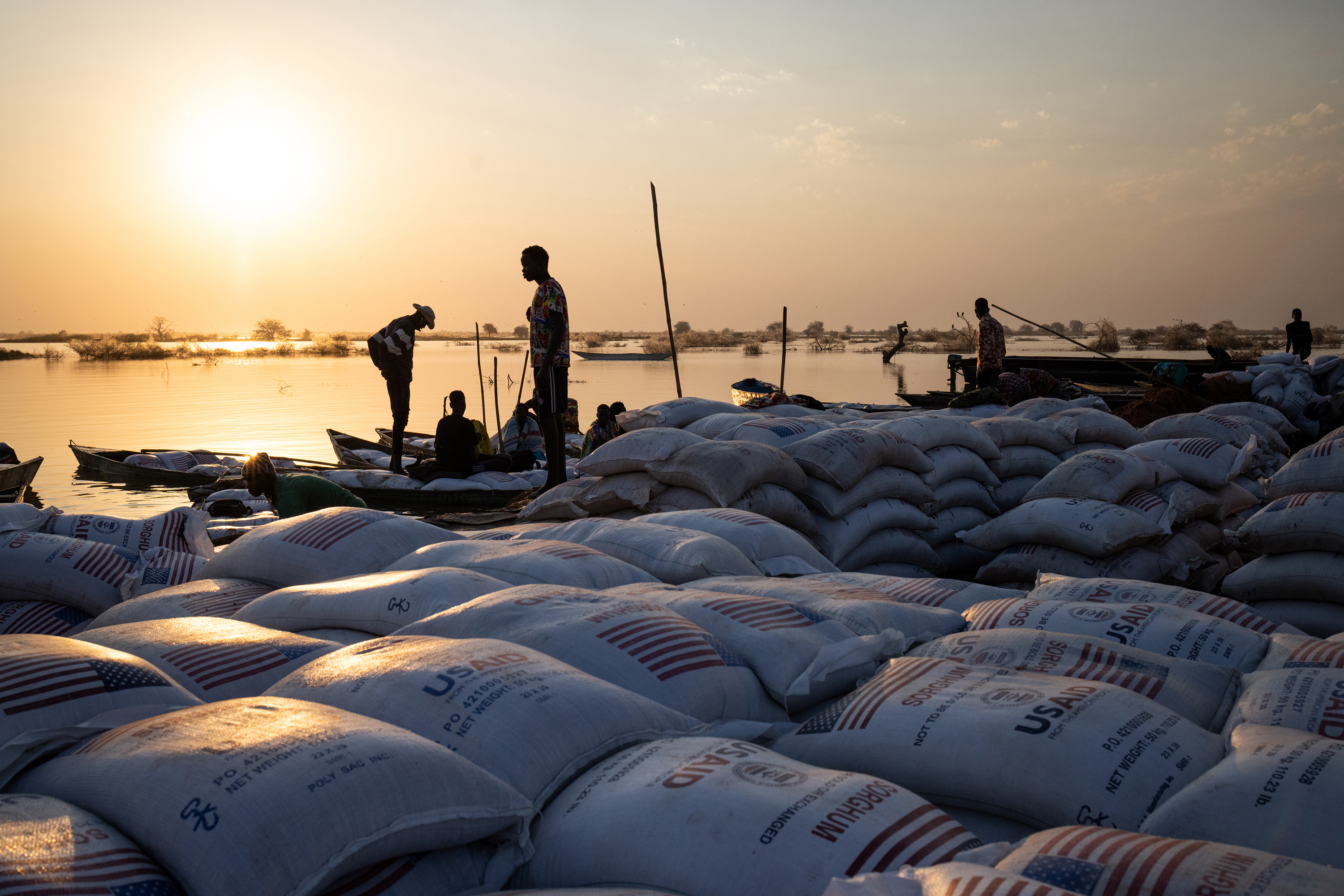 People delivering food aid in USAID bags in South Sudan. By Monday, the agency was effectively paralysed. Photo / Jim Huylebroek, The New York Times