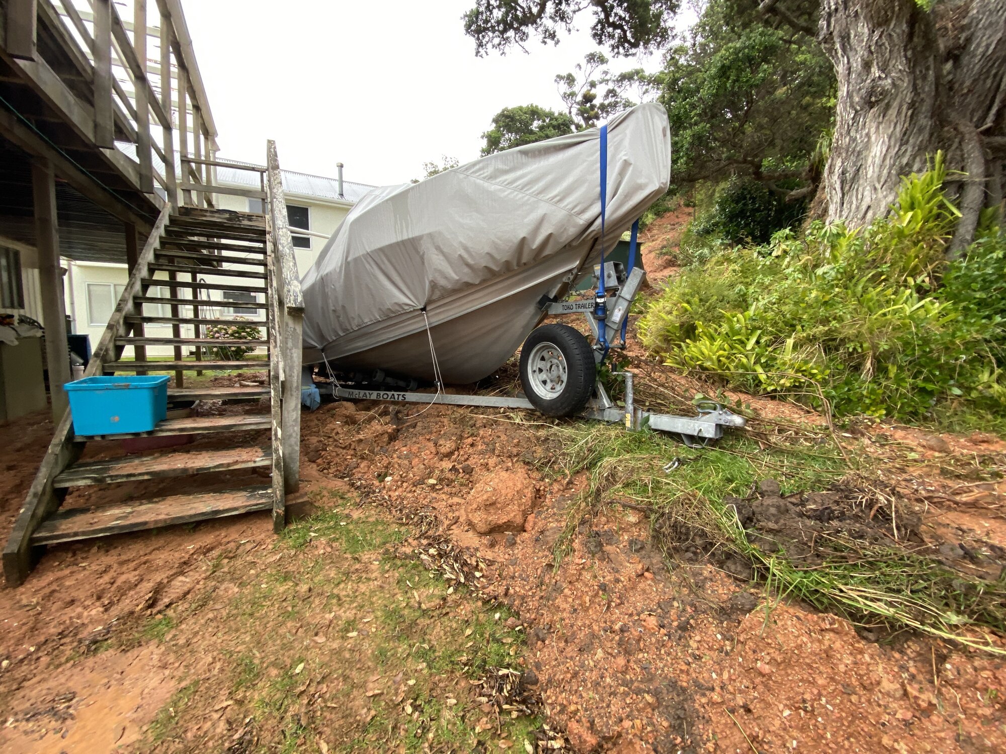 An Ōakura holiday home owner, who doesn't want to be named, says this slip came down with a mighty bang on Sunday morning but fortunately his boat stopped most of the clay. Photo / Denise Piper