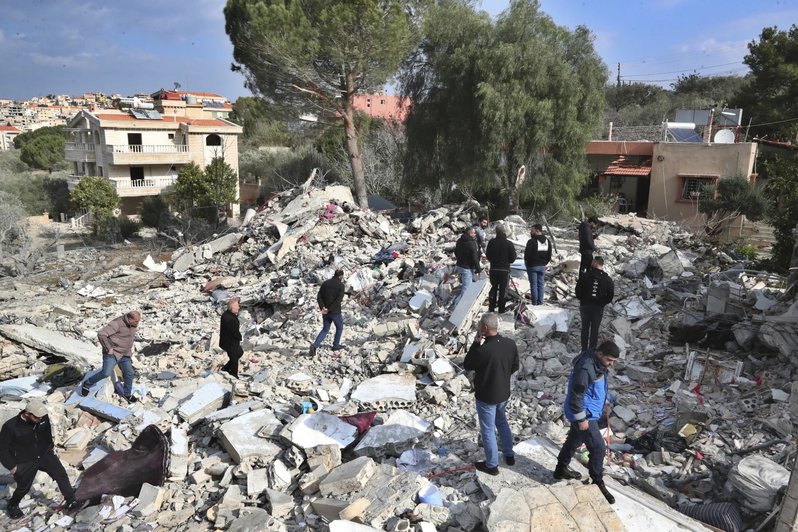 Lebanese citizens gather on the rubles of a house that was destroyed by an Israeli airstrike on Tuesday night, in Bint Jbeil, South Lebanon. Photo / AP