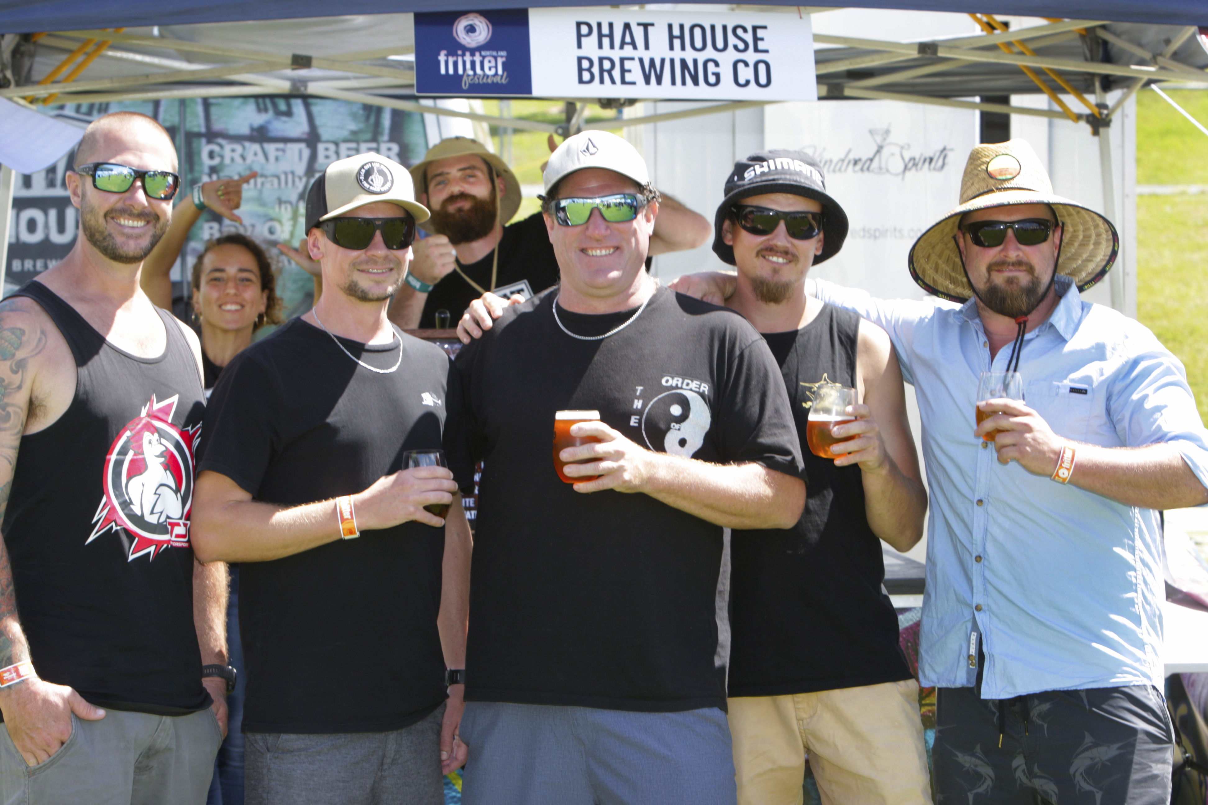 Matt Yovich, Brendyn Whitaker, Munch Burch, Mikale Meagher and James Hargraves have a beer while photobombed by Phat House Brewing's Kat Weeks and Connor Caswell. Photo / Tania Whyte