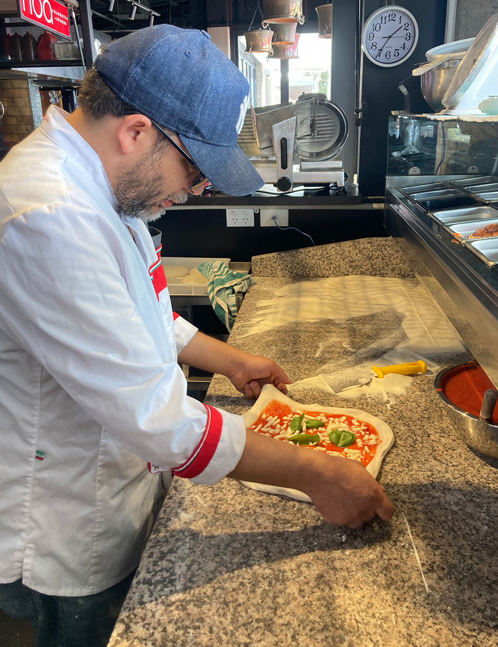 Dante's Chef Enis Bacova works on a Queen Margherita in the Eastridge Eatery restaurant. Photo / Madeleine Crutchley