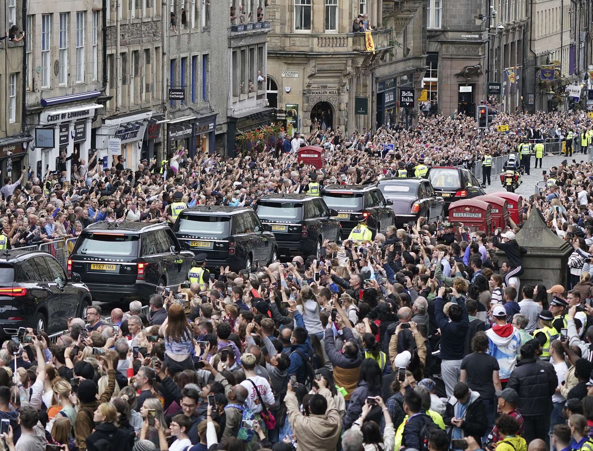 Crowds watch as the hearse carrying the coffin of Queen Elizabeth II passes Mercat Cross in Edinburgh. Photo / Ian Forsyth via AP)