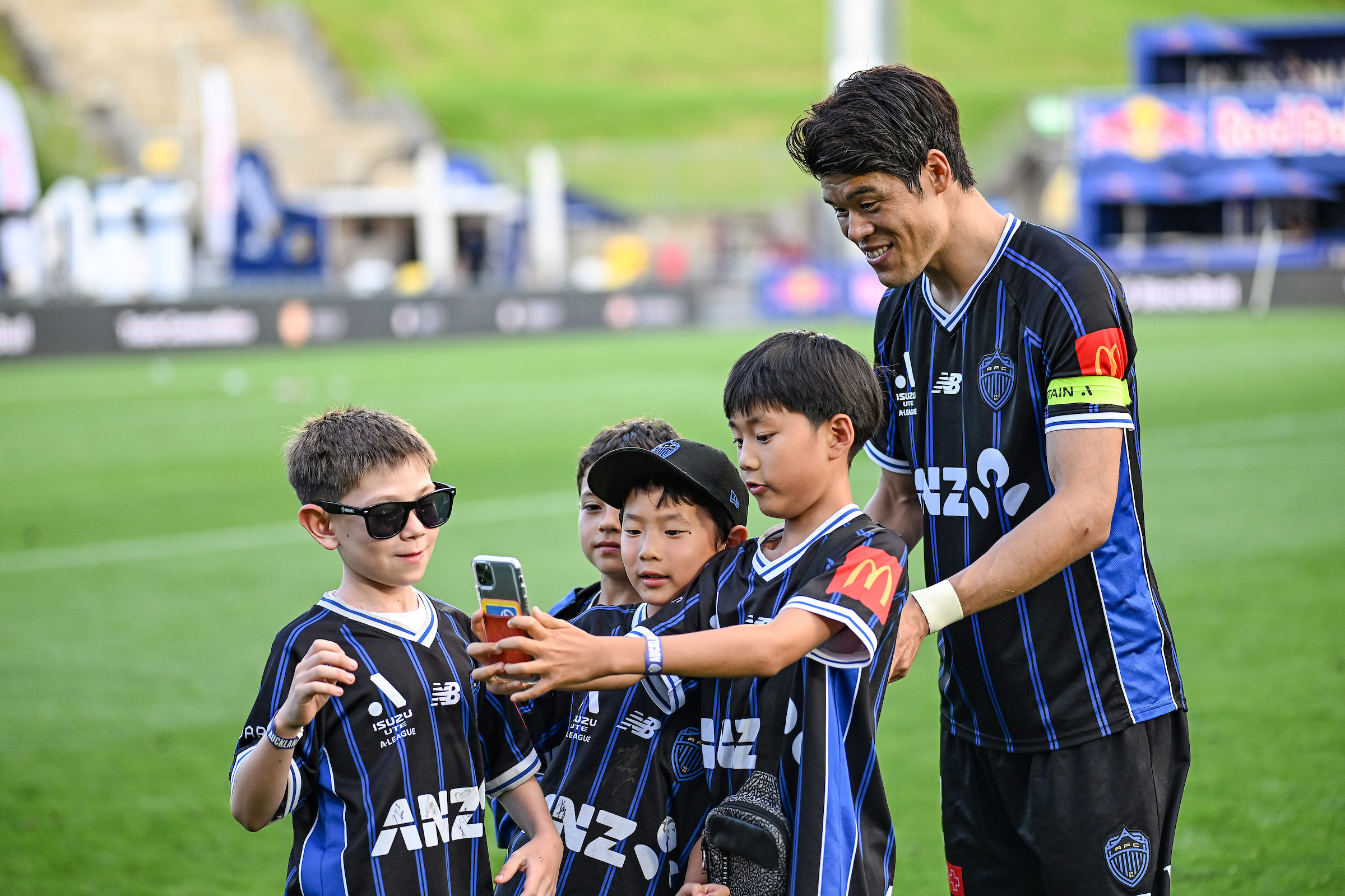 Hiroki Sakai of Auckland FC with young fans after a match. Photo / Photosport