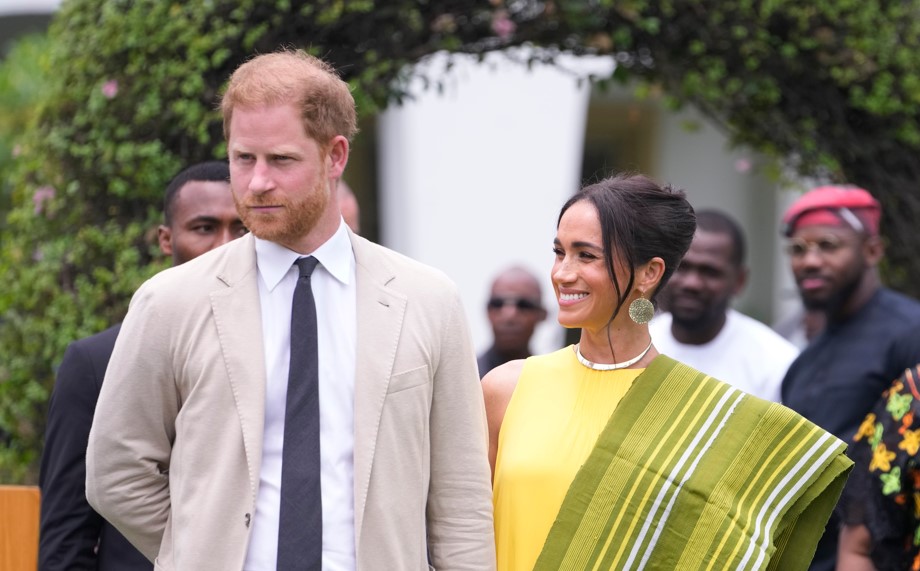 Prince Harry and Meghan, Duchess of Sussex, holding hands upon arrival at the government house in Lagos, Nigeria on Sunday. Photo / AP