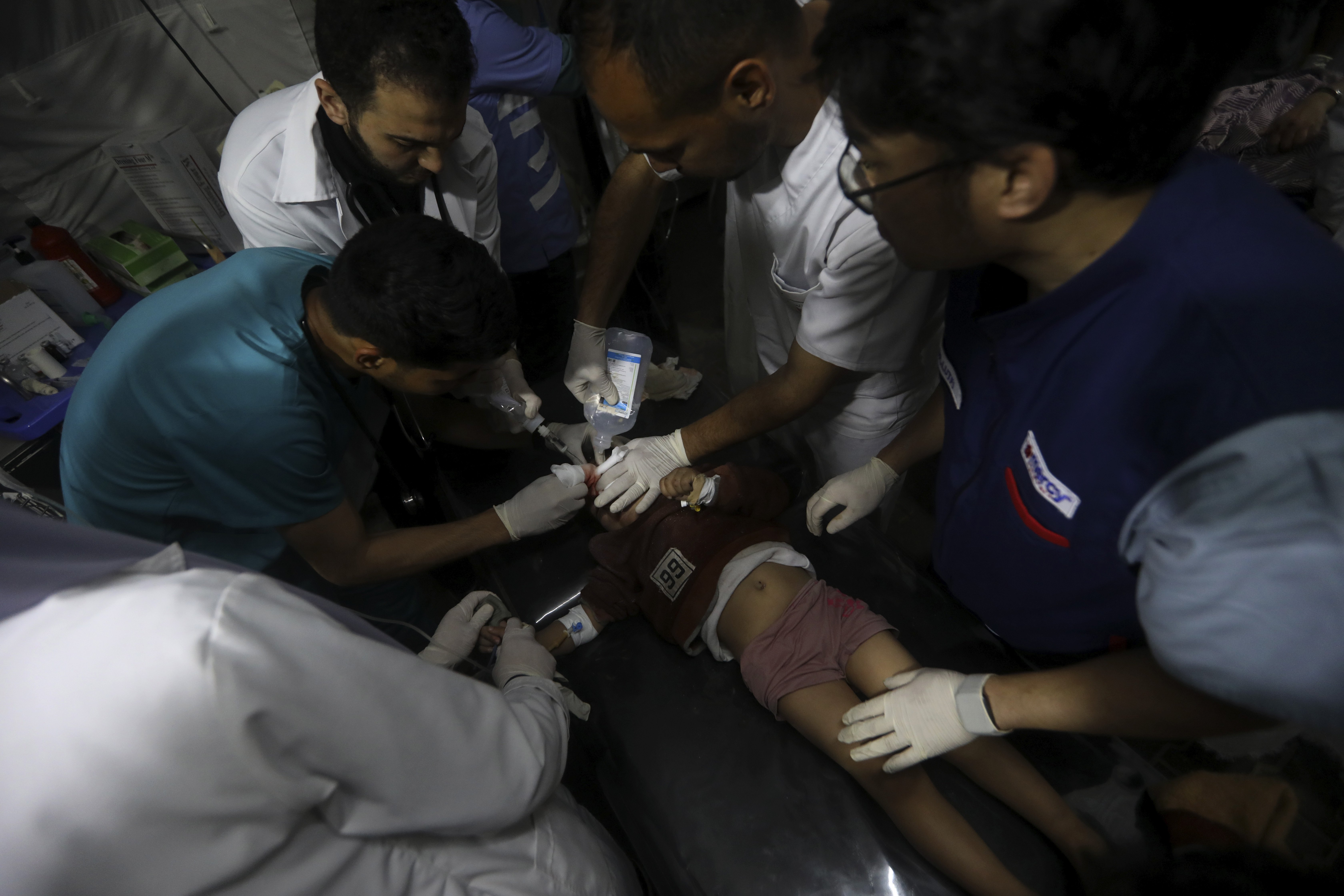 Palestinian medics treat a wounded in the Israeli bombardment of the Gaza Strip at the Kuwaiti Hospital in Rafah refugee camp, southern Gaza Strip. Photo / AP