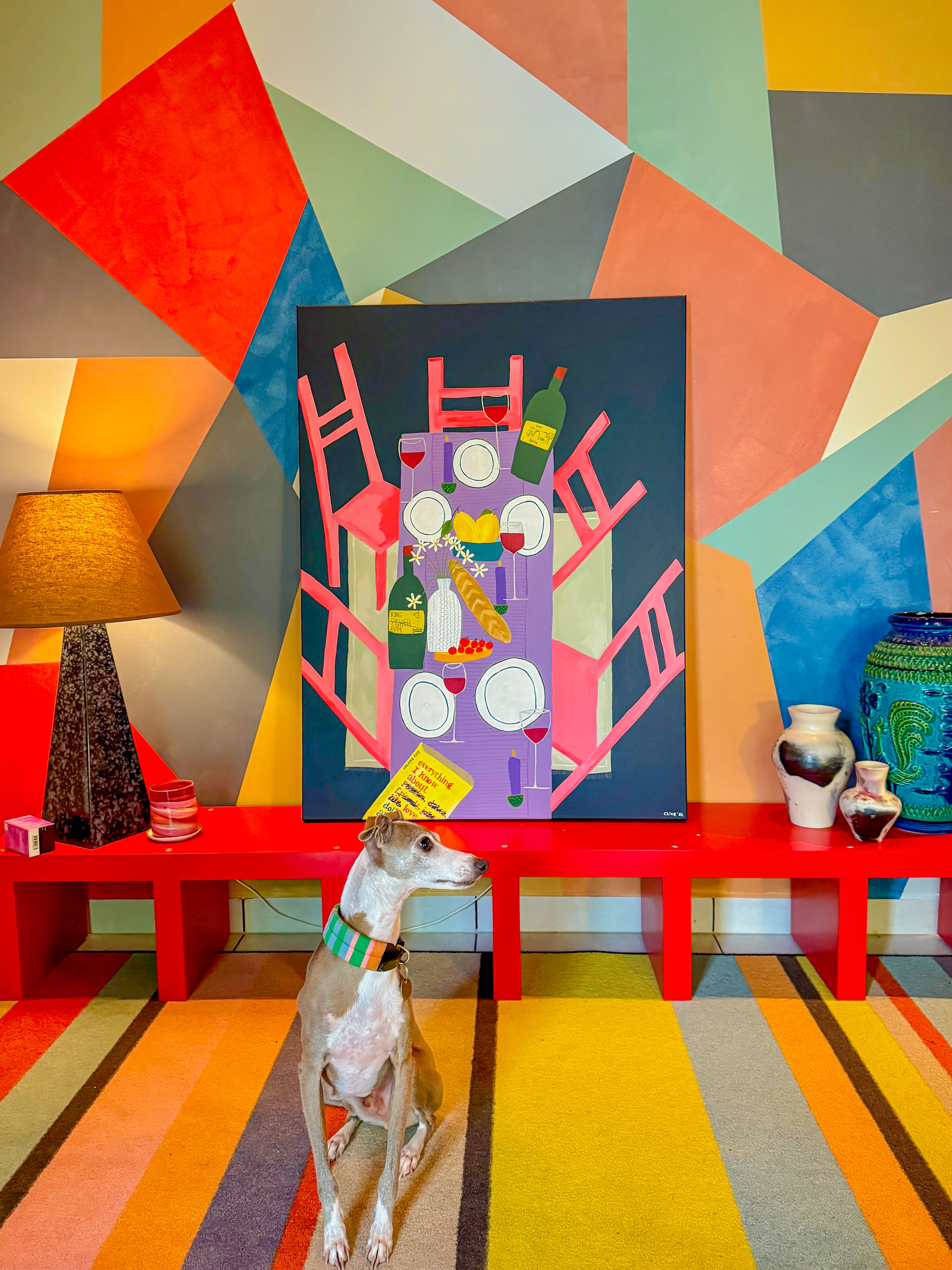 Evie’s dog Biggie in her hallway. The artwork on the table behind him is by Chloe Blades.