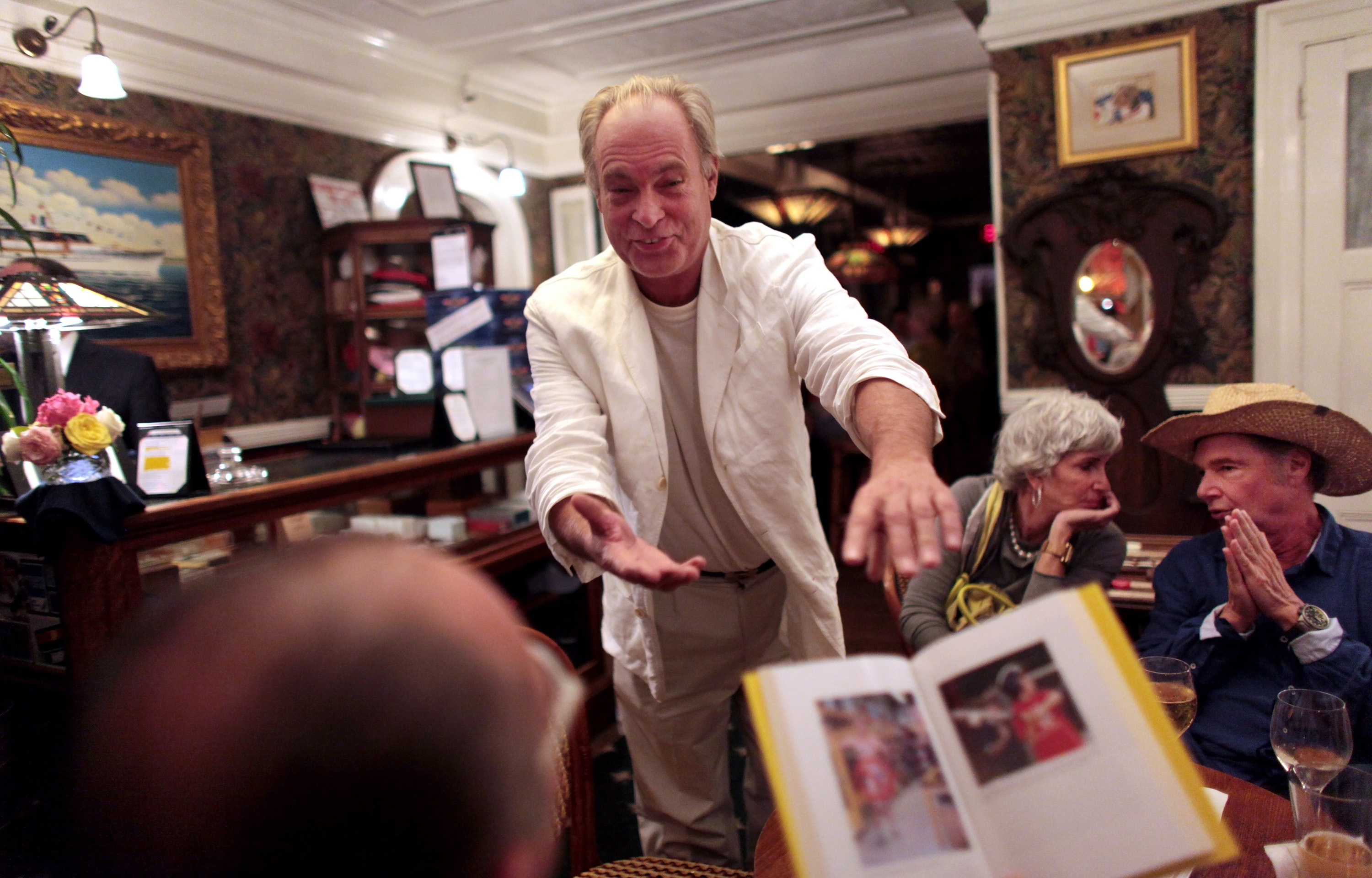 Author and journalist Harry Hurt III shows his book around at a party at The American Hotel in New York, July 2012. Photo / Yana Paskova, The New York Times