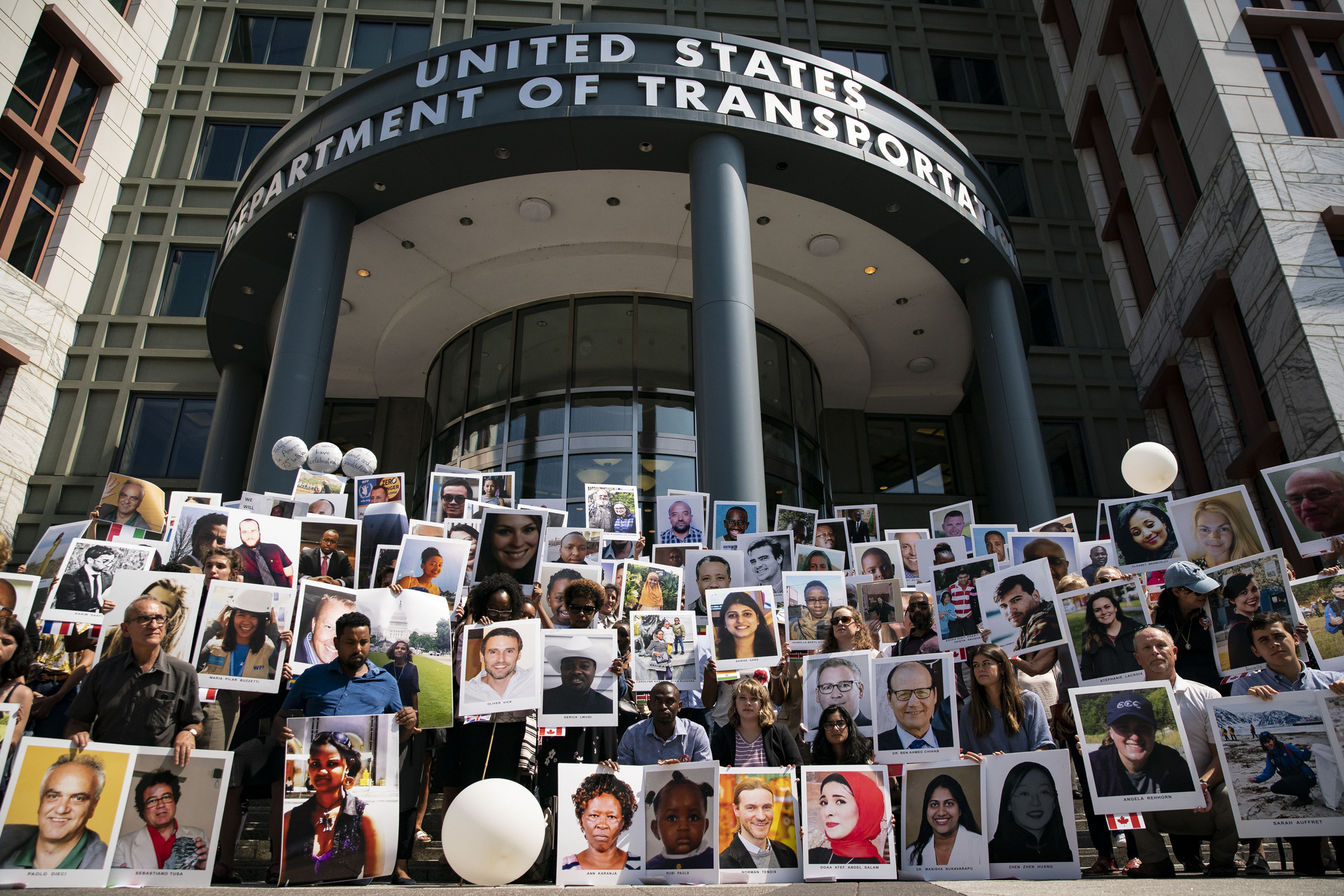 Family members of victims from the Ethiopian Airlines Flight 302 crash hold photographs during a vigil outside the Department of Transportation in Washington in 2019. Photo / Bloomberg via Getty Images