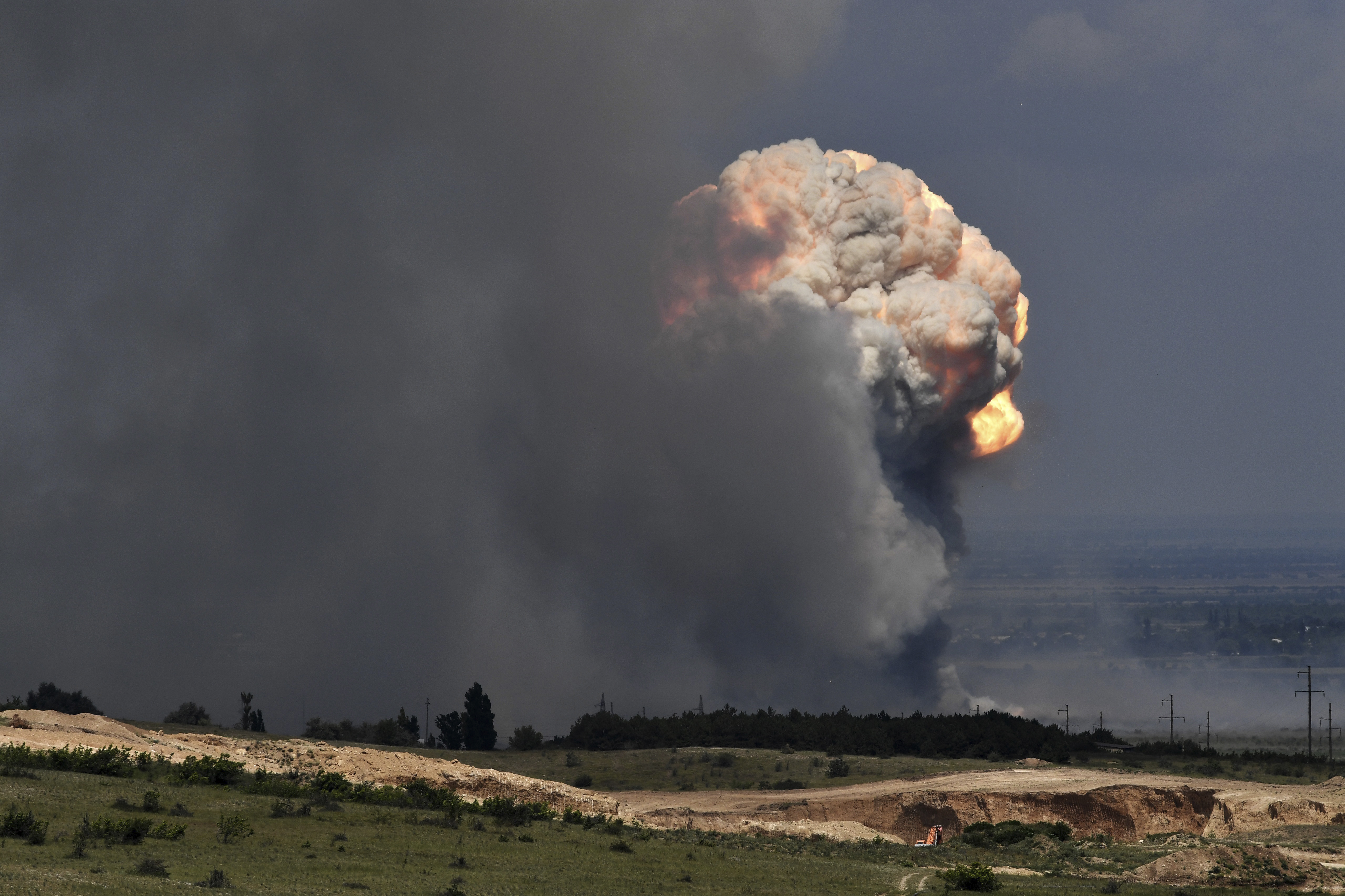 A plume of smoke rises over an ammunition depot where explosions occurred at the facility in Kirovsky district in Crimea. Photo / AP
