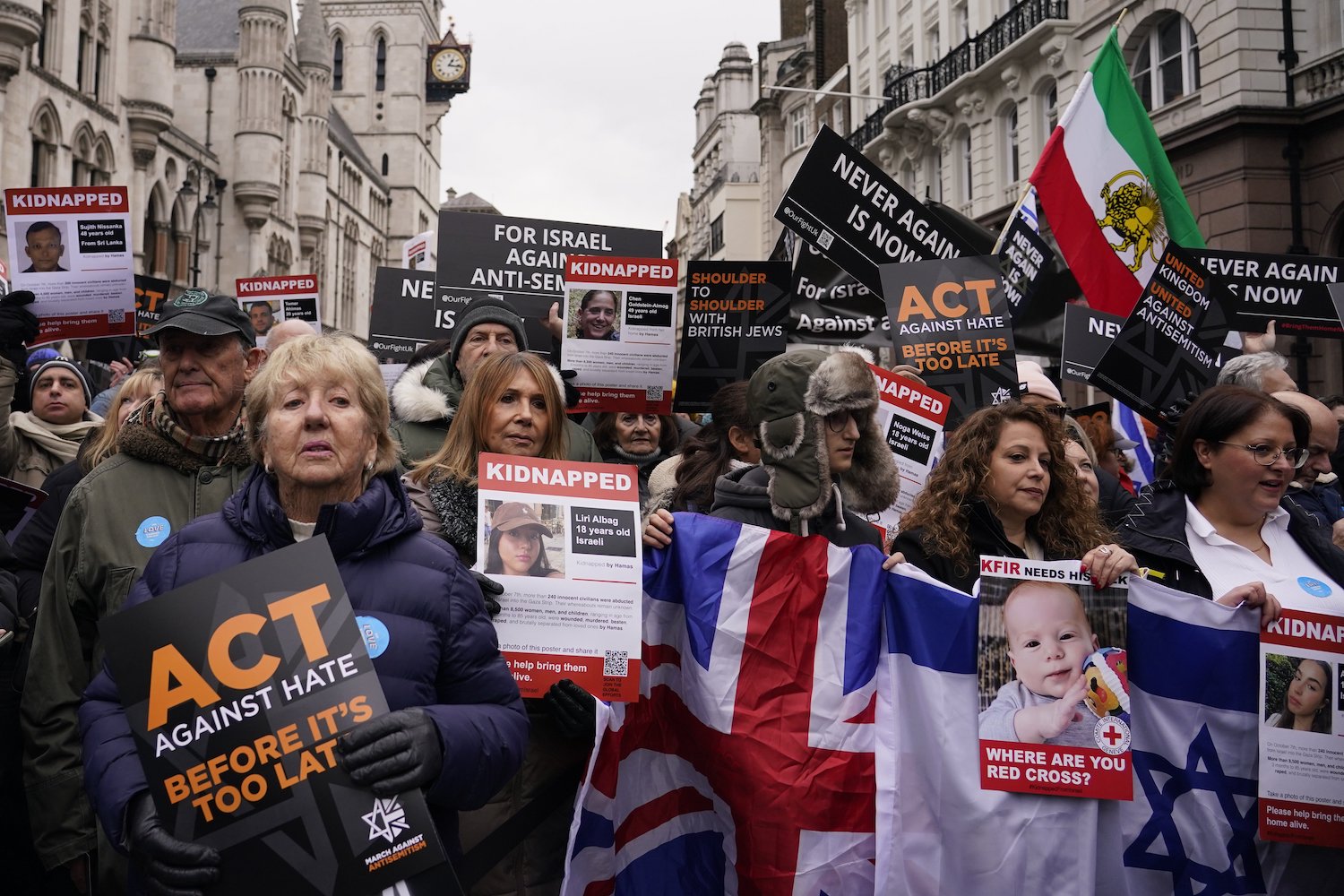Protesters holding placards flags and banners an anti-Semitism demonstration in London. Photo / AP