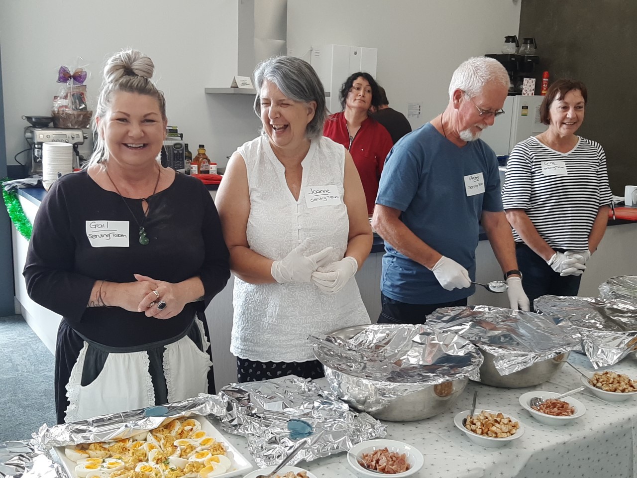 Volunteers are all smiles as they get ready to serve Christmas lunch at Whangārei Salvation Army.
Photo / Imran Ali