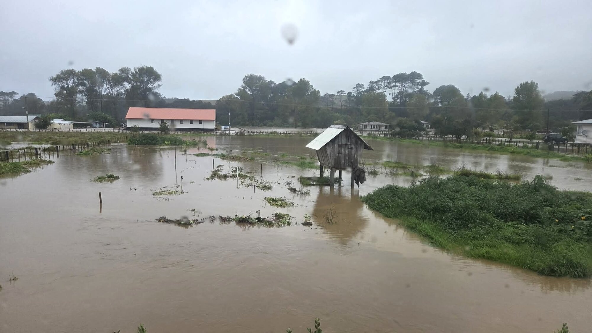 Roads turn to rivers in Whirinaki, South Hokianga, after the river burst its banks. Photo / Charles Wikaira