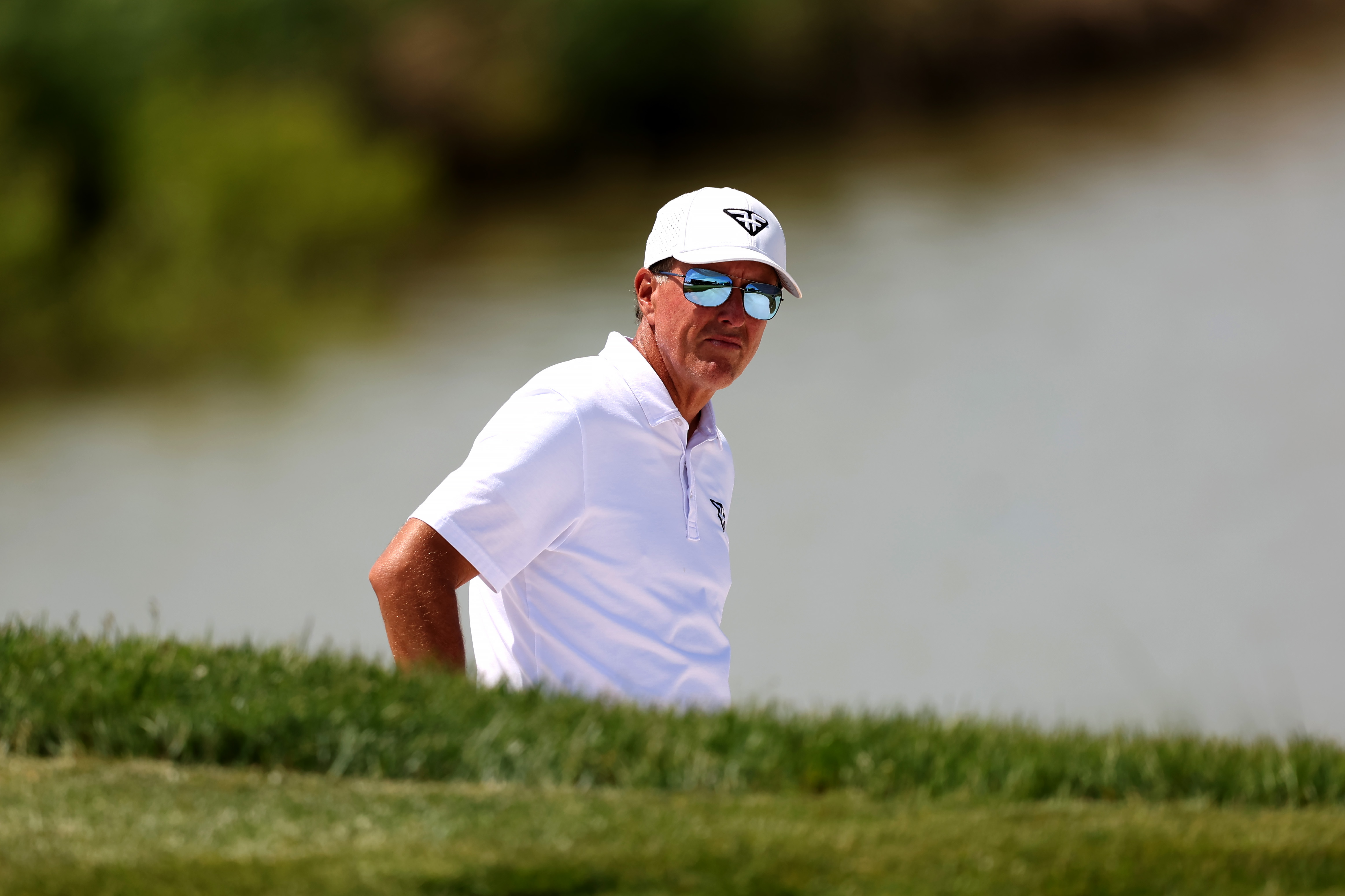 Phil Mickelson eyes his bunker shot at the LIV Golf Invitational. Photo / Getty Images