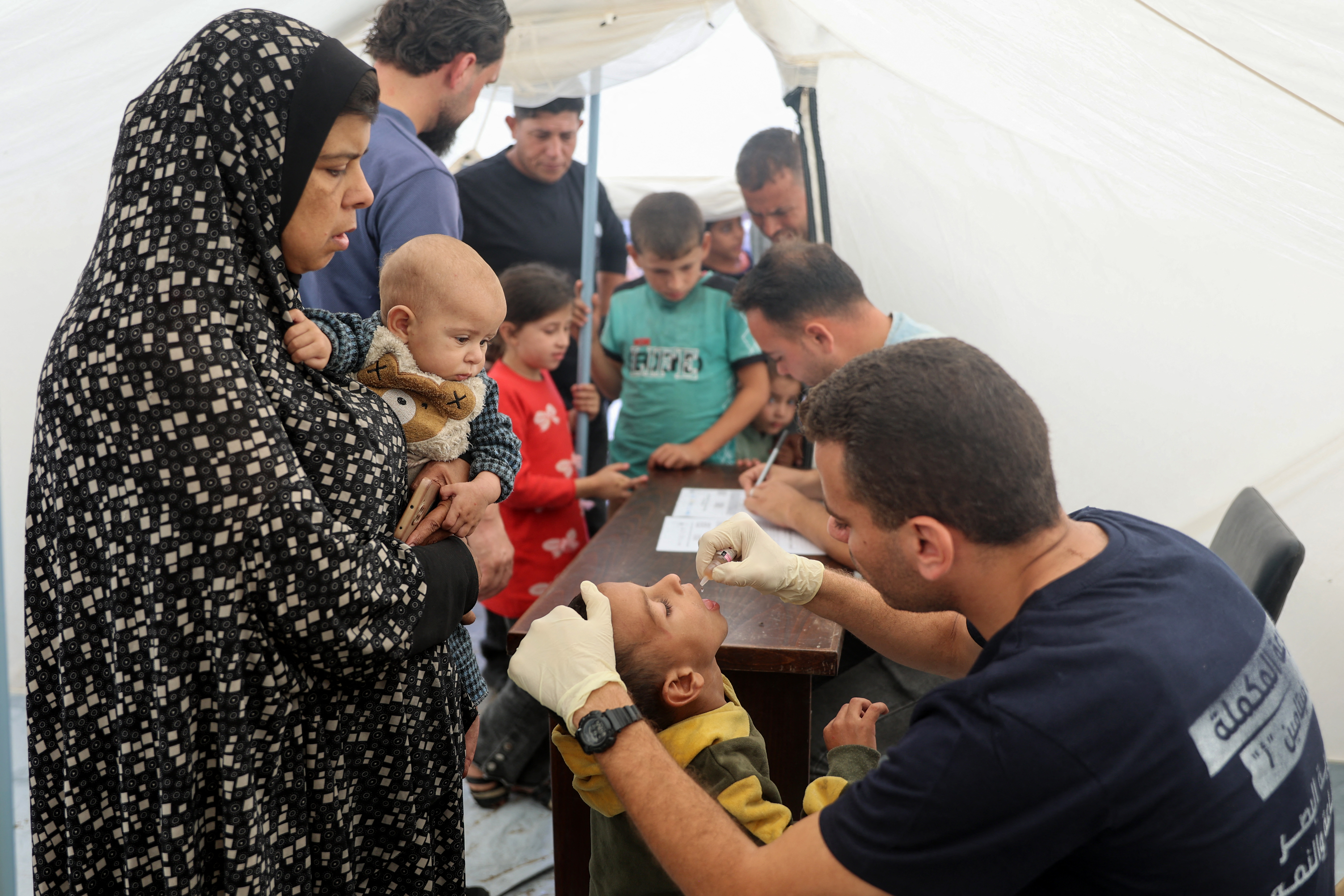 A medic administers a polio vaccine to a Palestinian child at a hospital in Gaza City's Nasr district which was reopened yesterday after sustaining heavy damage in Israeli bombardment of the area. Photo / AFP