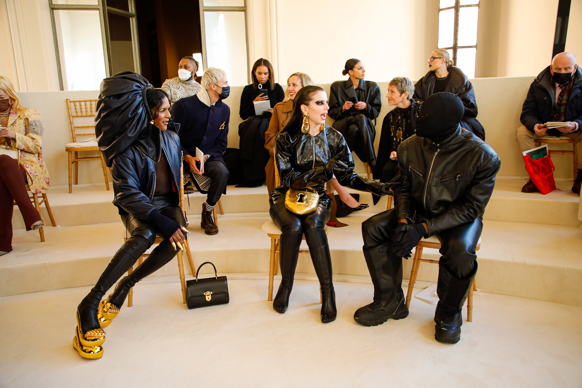 Julia Fox, centre, and Kanye West who had donned a balaclava, right, at the Schiaparelli couture show in Paris in January last year. Photo / The New York Times
