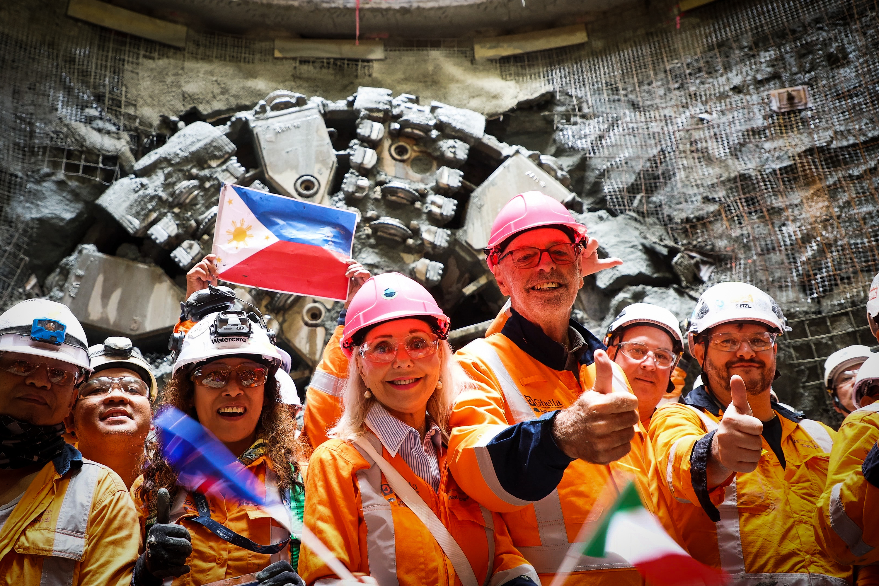 Mayor Wayne Brown and Deputy Mayor Desley Simpson celebrate with tunnellers after the Hiwa-i-te-Rangi tunnel boring machine has broken through. Photo / Michael Craig
