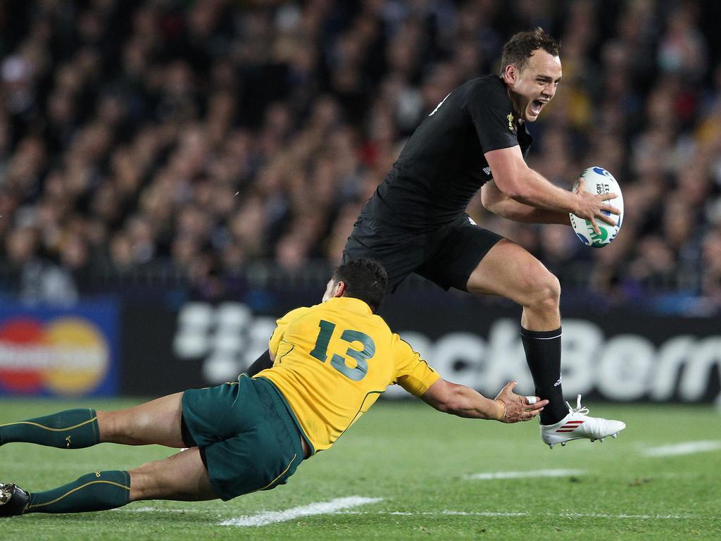 Israel Dagg leaps over Australia's Anthony Fainga'a in the 2011 Rugby World Cup semifinal at Eden Park. Picture / Greg Bowker