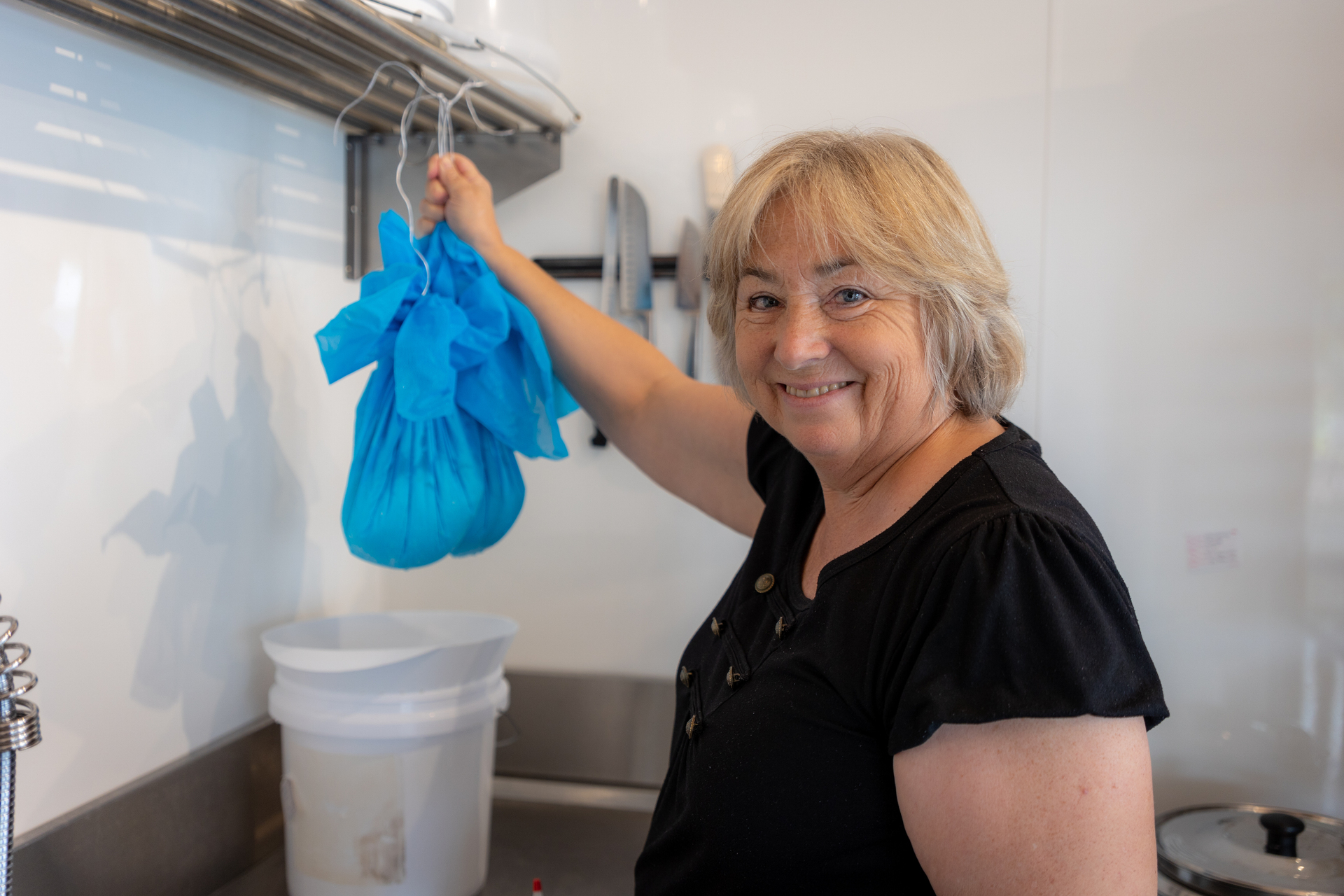 Jennifer Rodrigue hanging cheeses in her creamery. Photo / Donna Russell