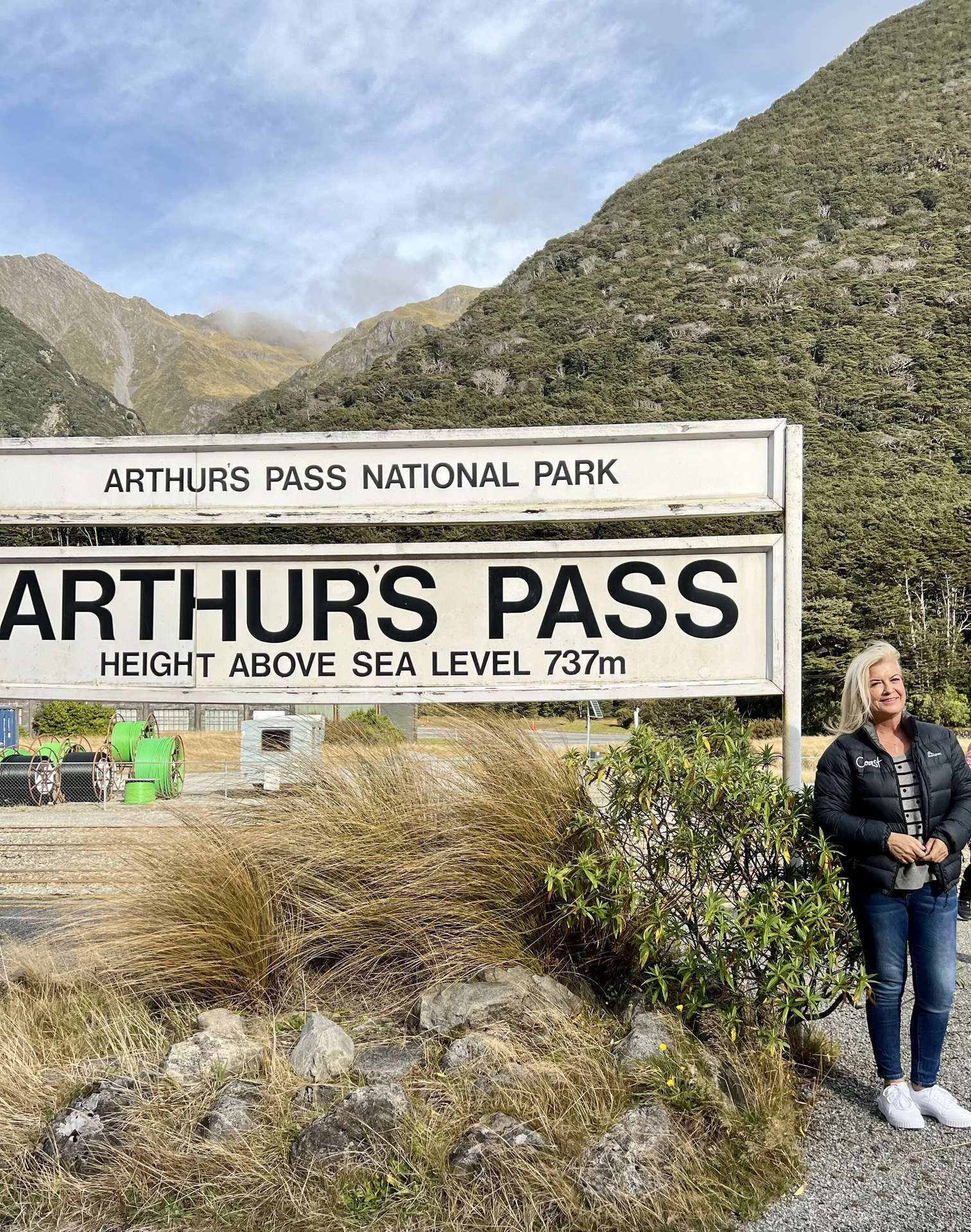 A photo op and a stretch of the legs at the highest mountain pass in the Southern Alps. Photo / Supplied