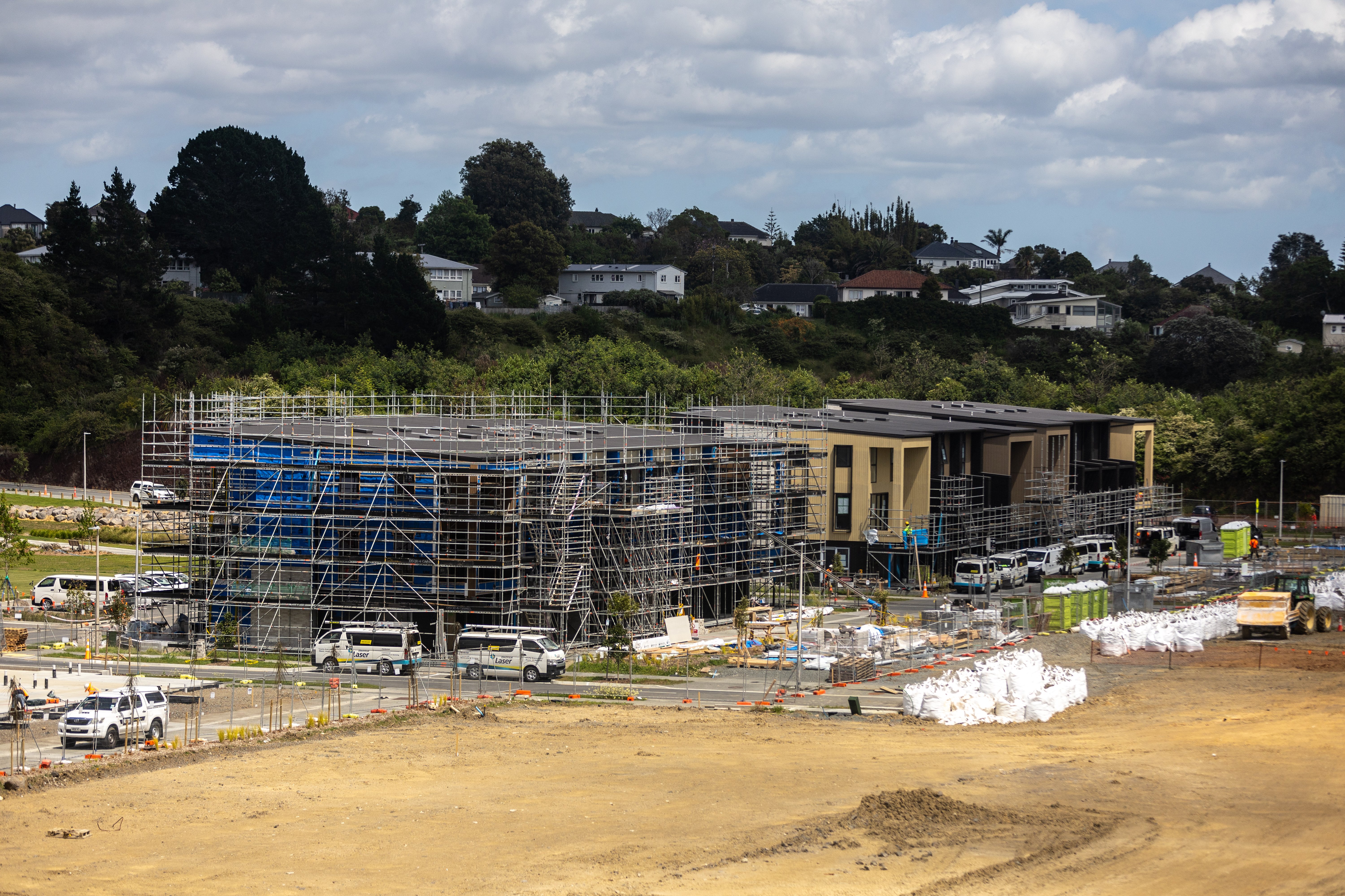 Some of the new terrace homes still have scaffolding while others are more advanced. This is in the ex-Winstone quarry at Three Kings where Fletcher Living is building. Photo / Michael Craig