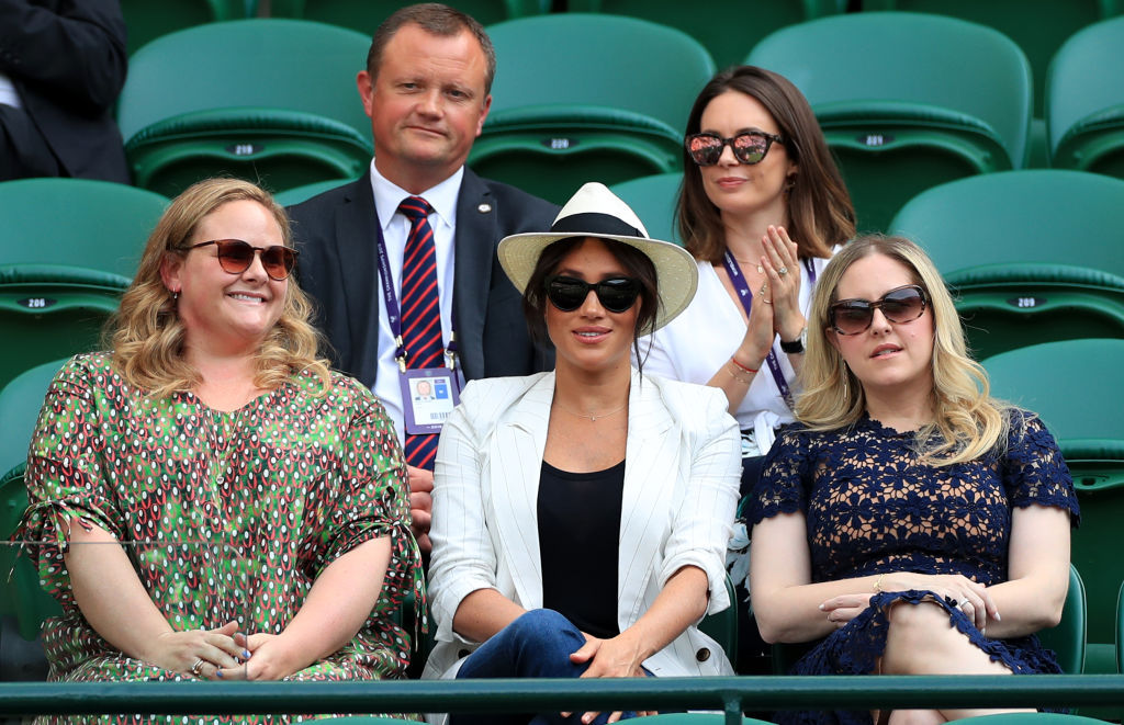 Meghan Markle flanked by friends as she watches Serena Williams' game at Wimbledon. Photo / Getty Images