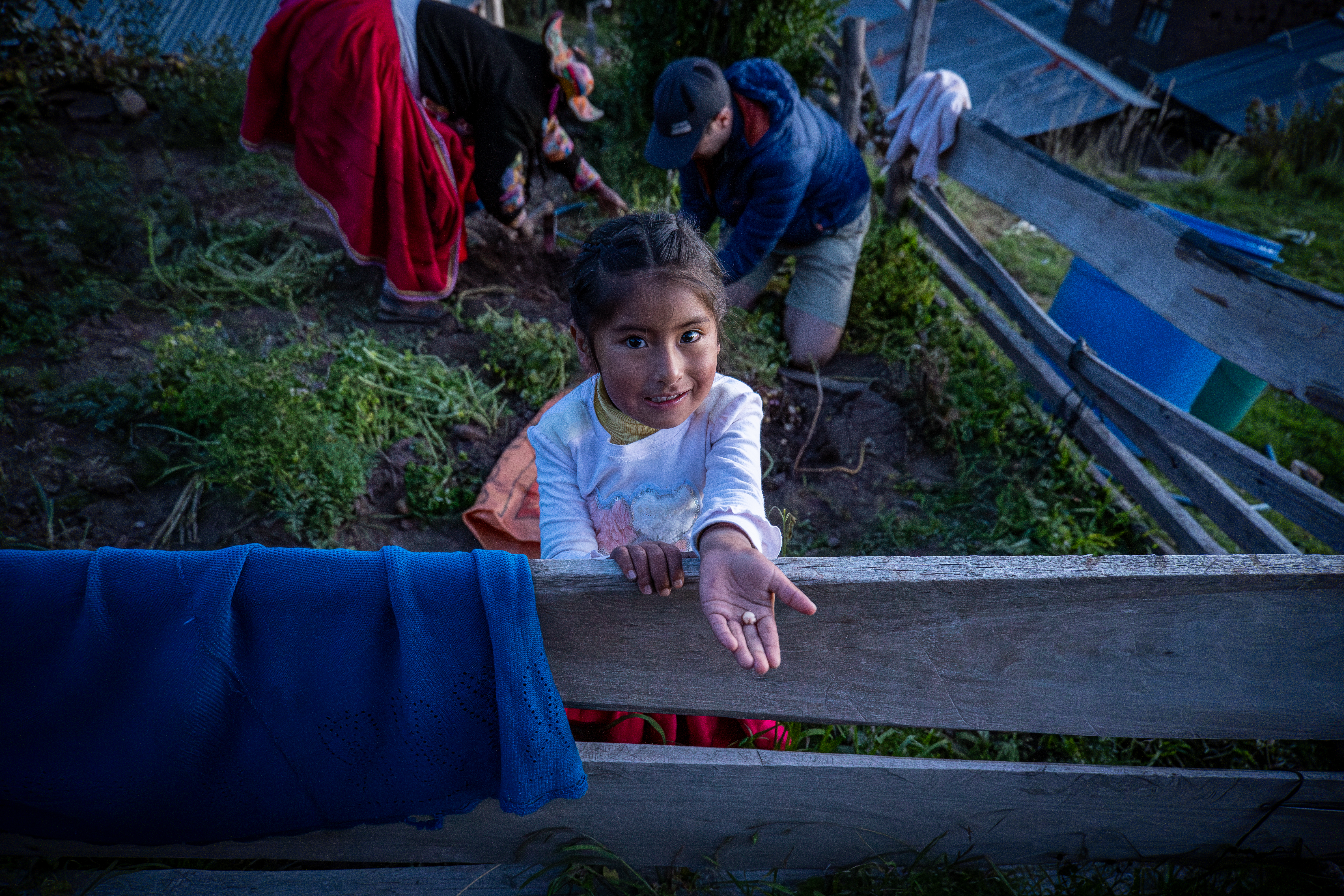 Shami, 4, with a tiny potato in the village of Llachon, Peru. Photo / Ricky French