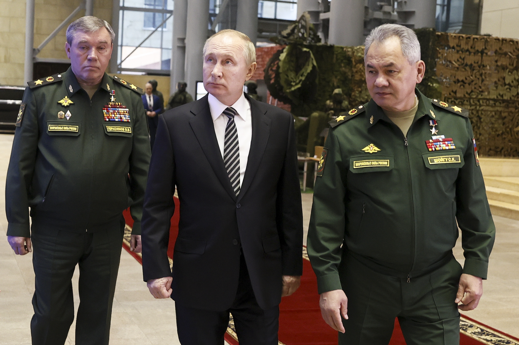 Russian President Vladimir Putin, centre, escorted by Russian Defence Minister Sergei Shoigu, right, and General Staff Valery Gerasimov. Photo / AP
