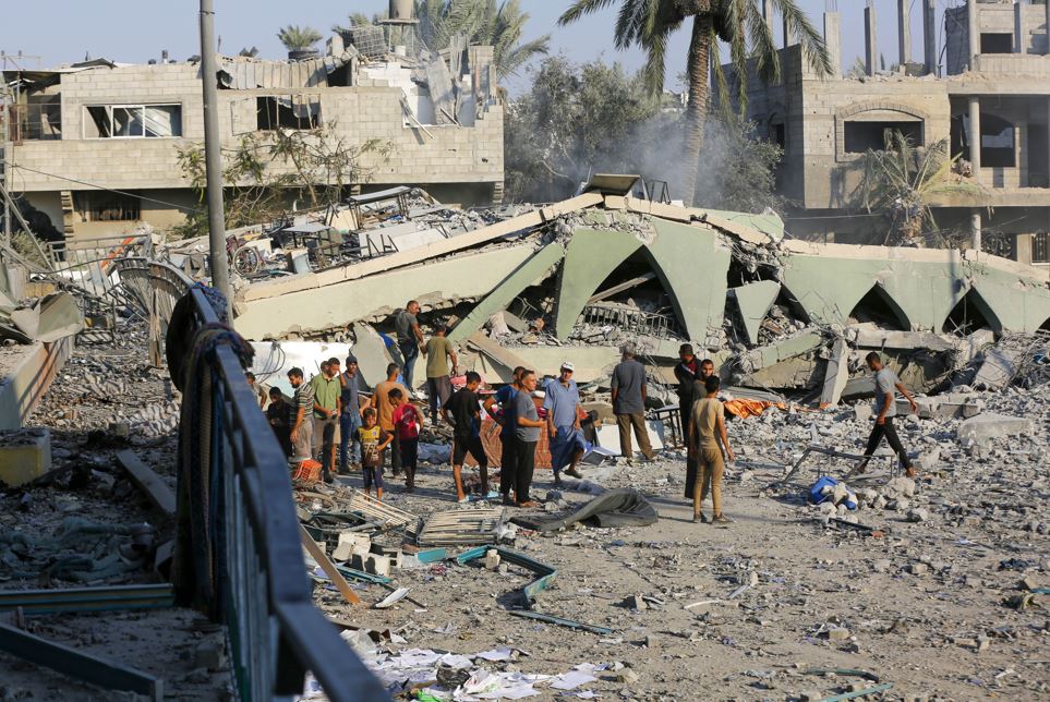 Palestinians seek for their belongings among wreckage as they flee to other areas after an Israeli attack struck Khadija School, which also served as a field hospital in Deir al-Balah, Gaza. Photo / Getty Images