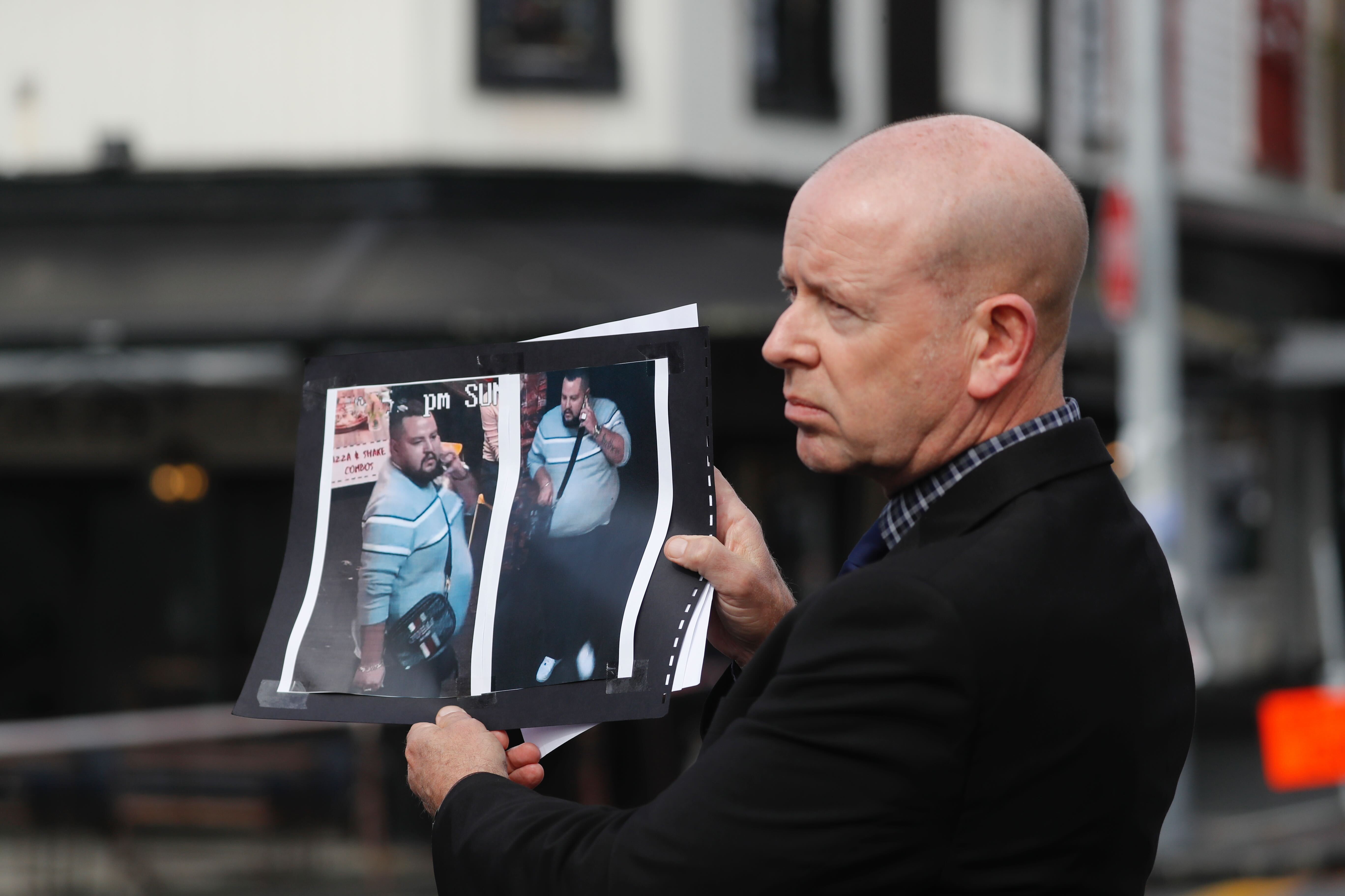 Detective Inspector Chris Barry shows images of the suspect wanted in relation to the shooting on Ponsonby Rd last night. Photo / Dean Purcell