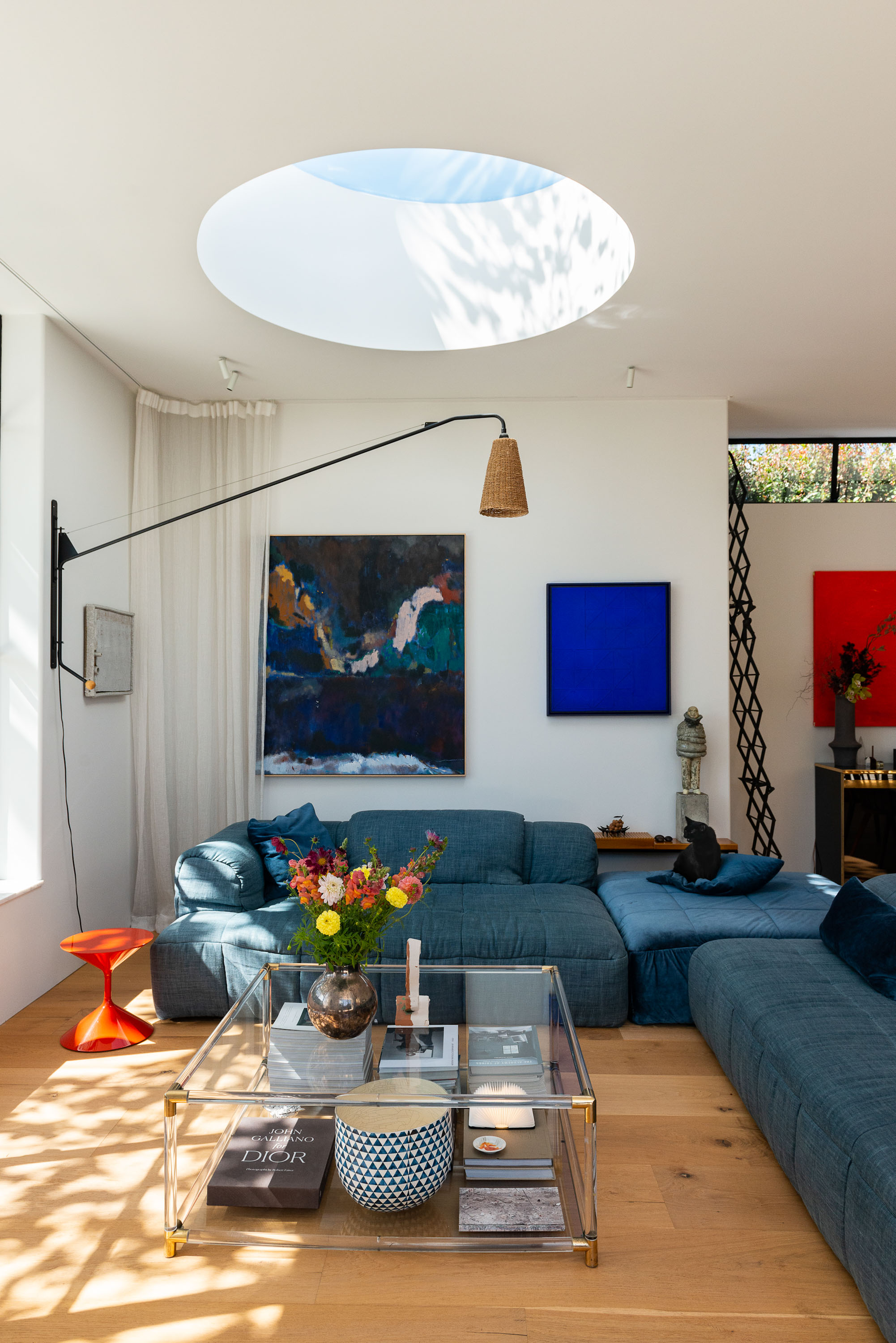 Interior stylist Sarah Lods' home is filled with art, including this large abstract by Matt Arbuckle. To the left, is an artwork by Jake Walker, and the blue artwork is by Australian artist Christian Lock. To the right, is a piece by Sally Gabori. Photo / Cave Bureau