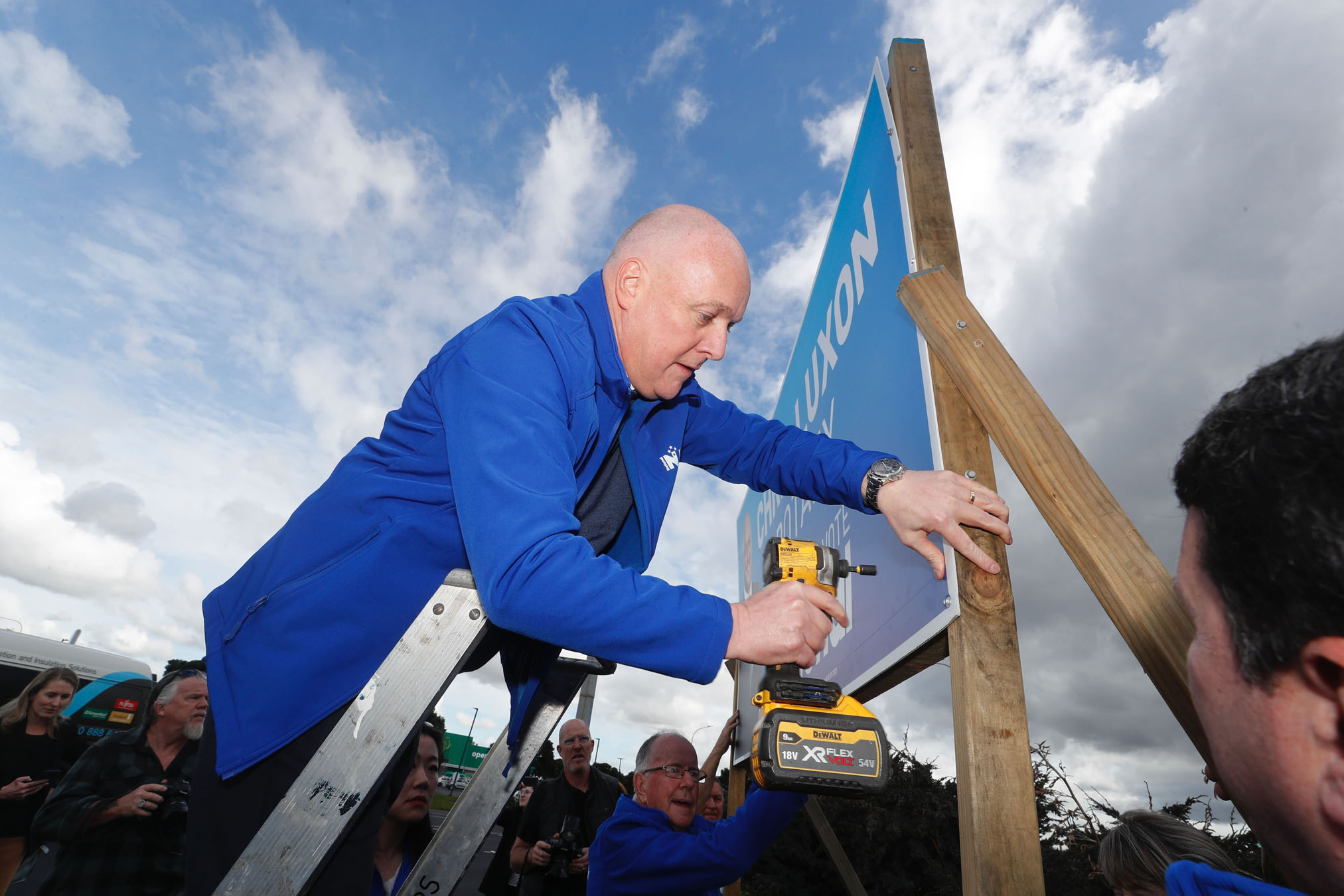 National leader, Christopher Luxon with the help of his dad Graham Luxon puts up the first campaign boards at Botany.
New Zealand Herald photograph by Dean Purcell