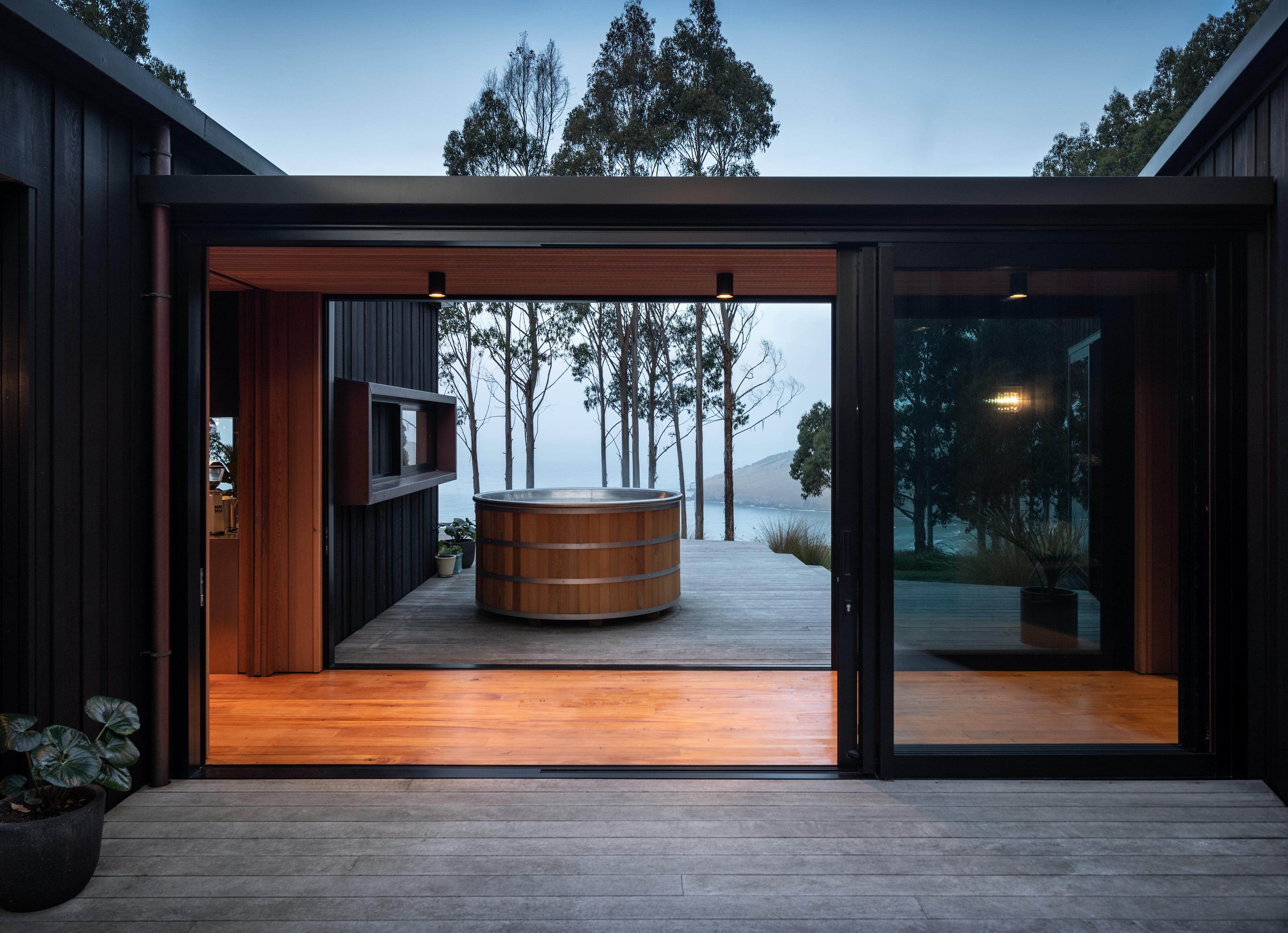 A glazed link creates an H-shaped plan, and borders on two protected decks. Photo / Simon Devitt