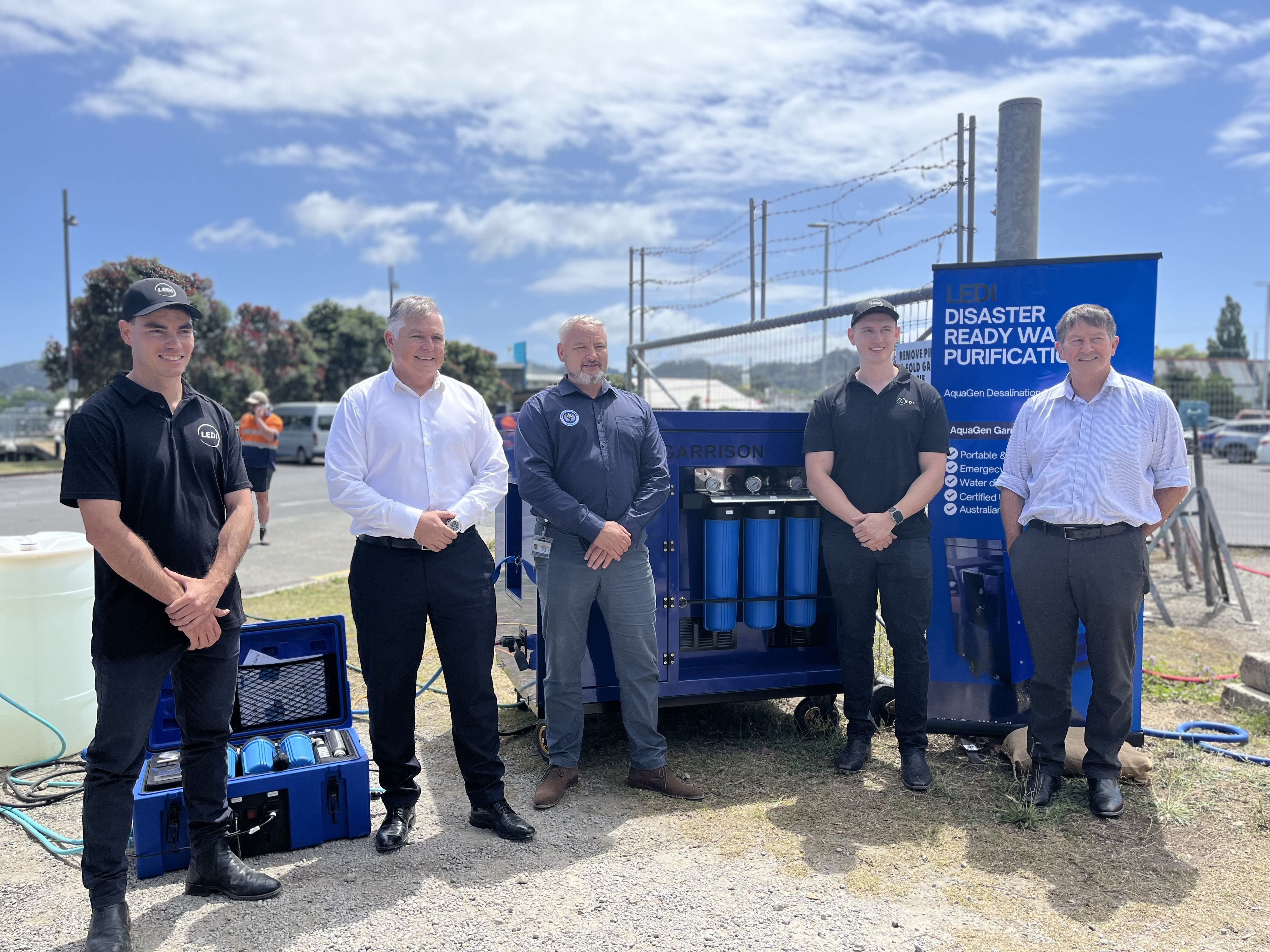 A new water filtration being deployed by the Tairāwhiti Emergency Management group is the first of its kind worldwide. Pictured at a Temo demonstration day at Gisborne's inner harbour on Friday are (from left) LEDI systems engineer Rhys McCormack, Emergency Management and Recovery Minister Mark Mitchell, Temo group manager Ben Green, LEDI founder and engineer Dael Liddicoat and National Emergency Management Agency chief executive Dave Gawn. Photo / Zita Campbell