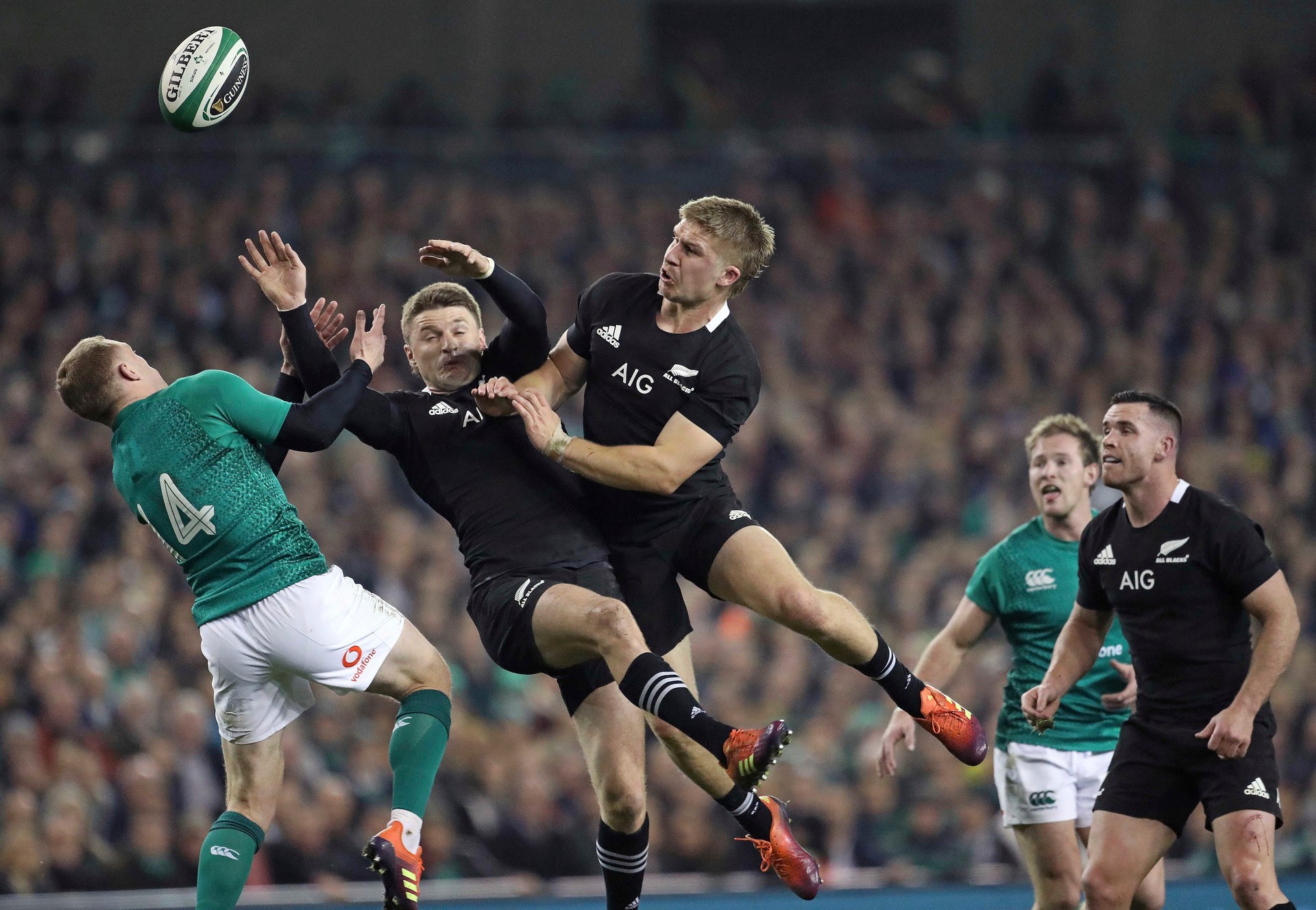 Ireland's Keith Earls, left, and New Zealand's Beauden Barrett, center, battle for a high ball during the rugby union international between Ireland and the New Zealand All Blacks. Photo / AP