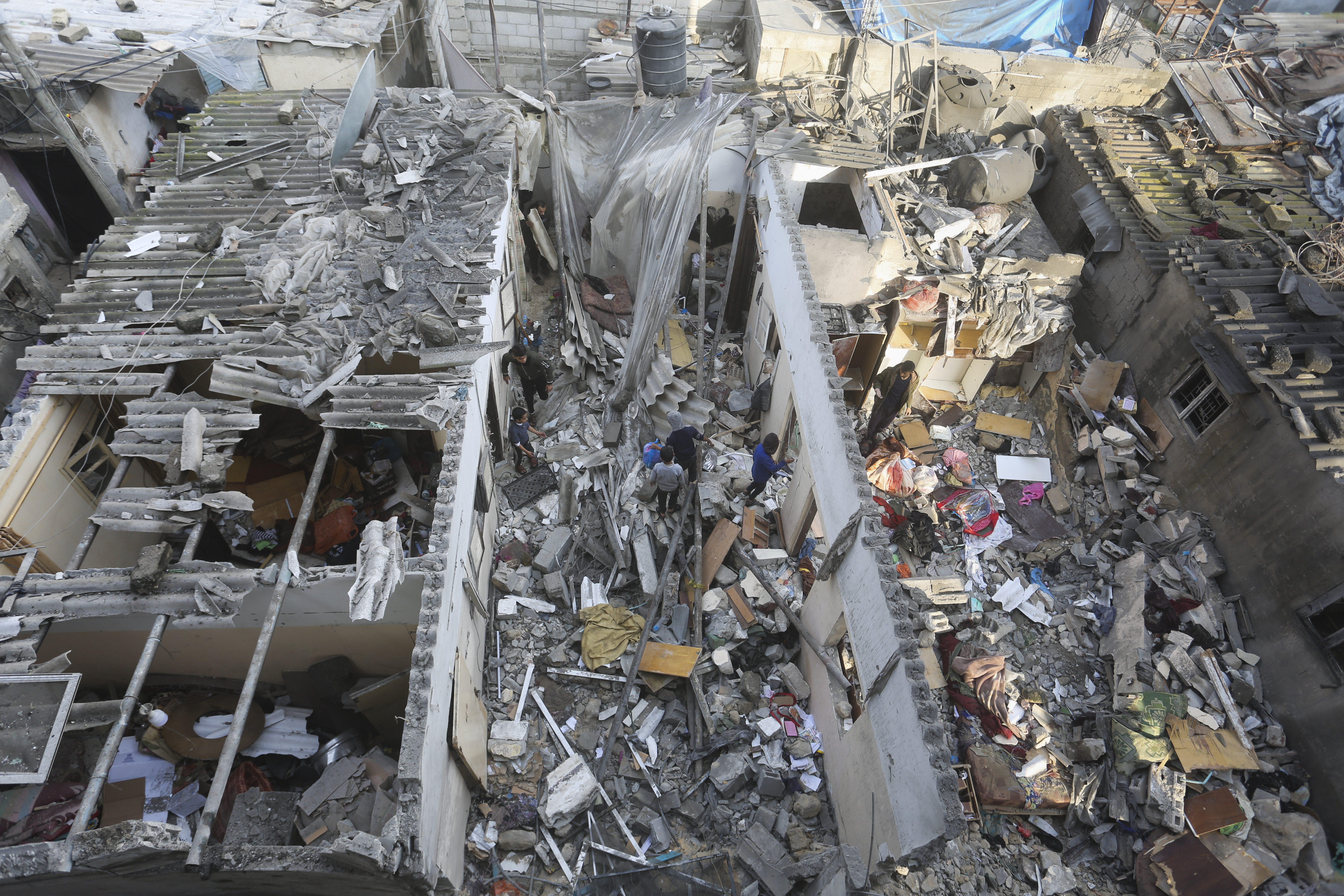 Palestinians salvage belongings after an Israeli strike on residential buildings in Rafah yesterday. Photo / AP