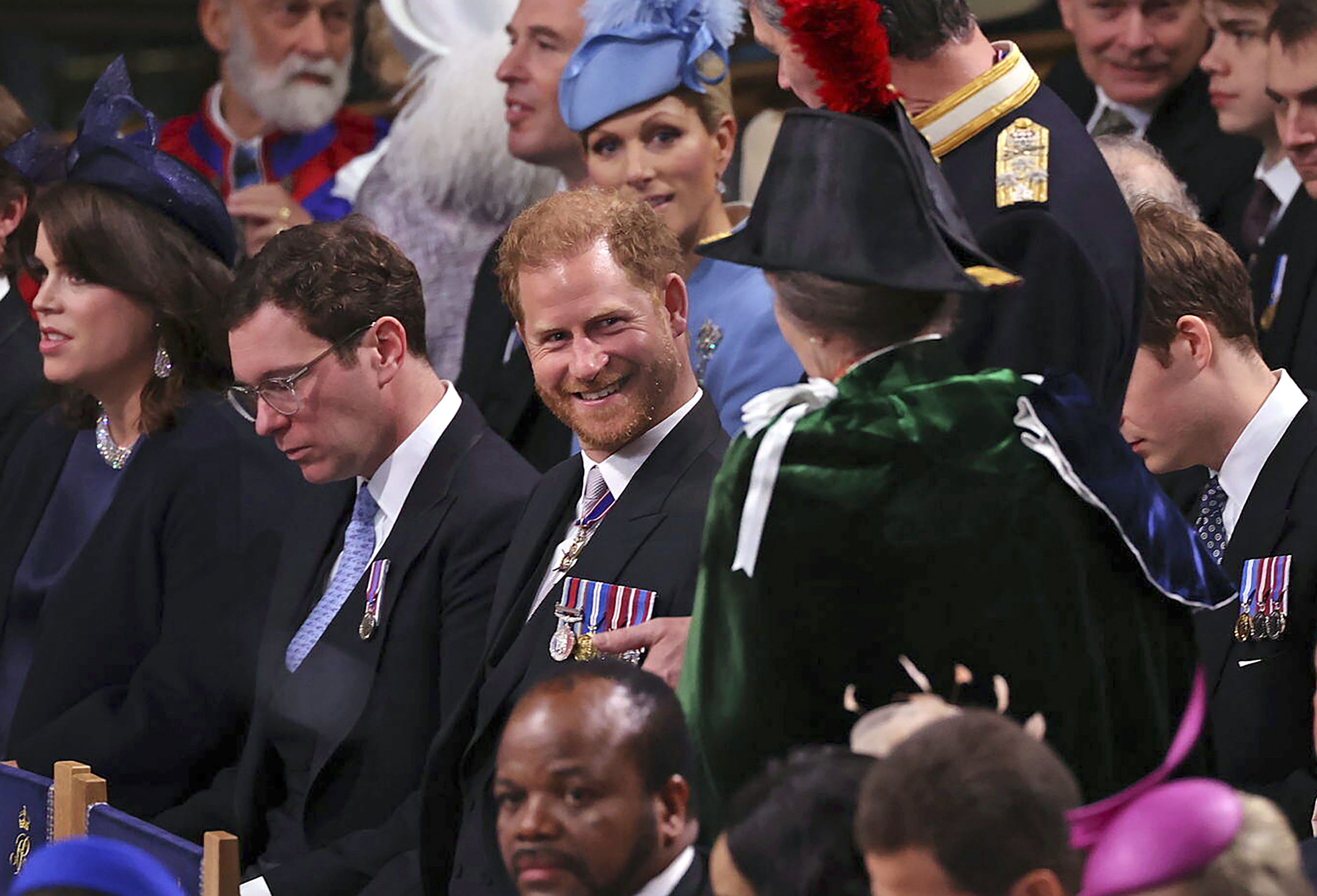 Prince Harry, centre, speaks with Anne, the Princess Royal in Westminster Abbey, ahead of the coronation of King Charles III and Camilla, the Queen Consort, in London, Saturday, May 6, 2023. (Richard Pohle /Pool via AP)