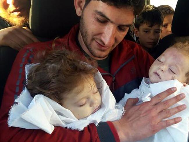 Abdul-Hamid Alyousef holds his twin babies who were killed during the attack, in Khan Sheikhoun and became the face of the global outcry. Photo/AP