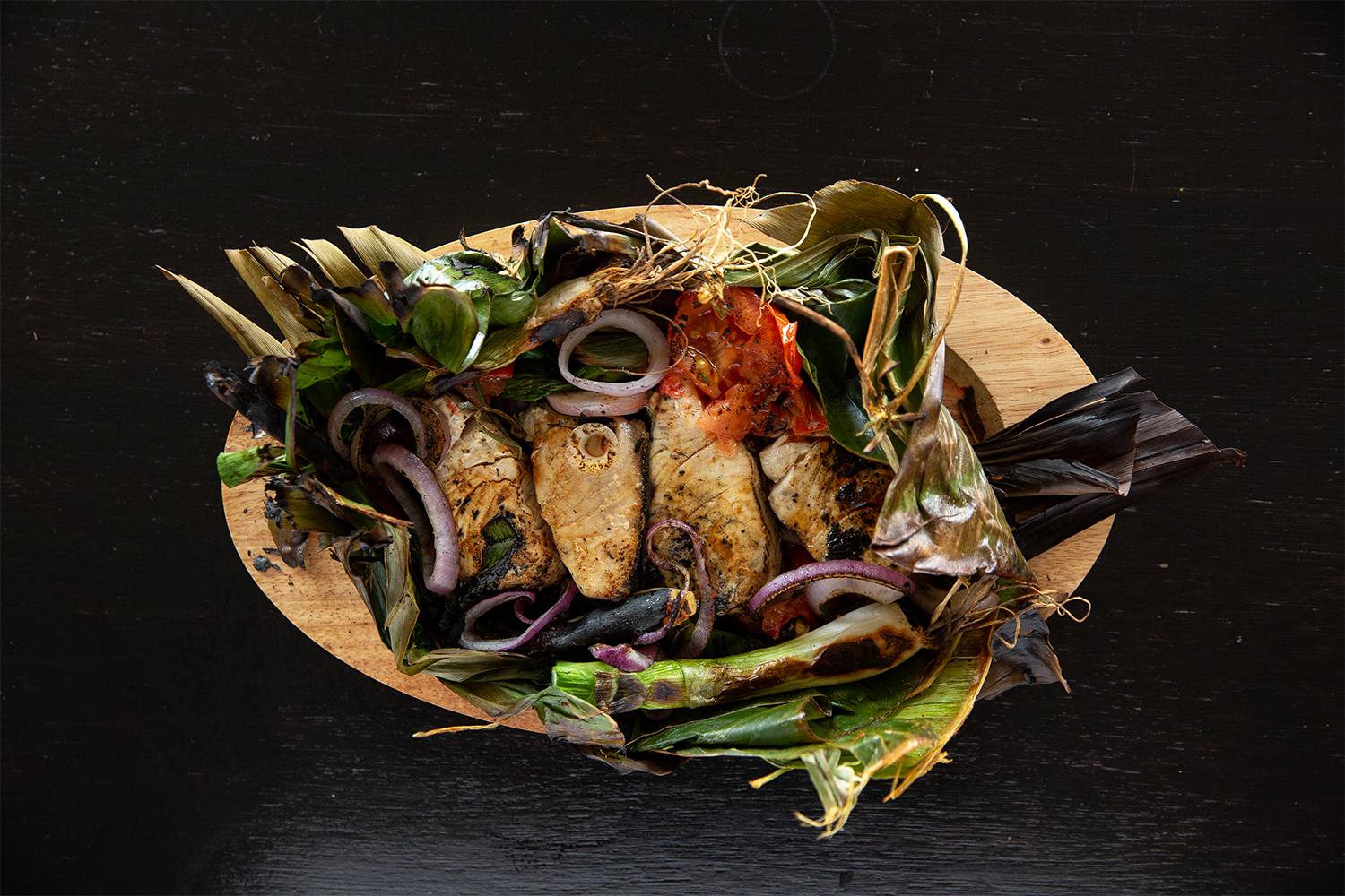 Sugba fish is wrapped in banana leaf and grilled on coals. Photo / Babiche Martens