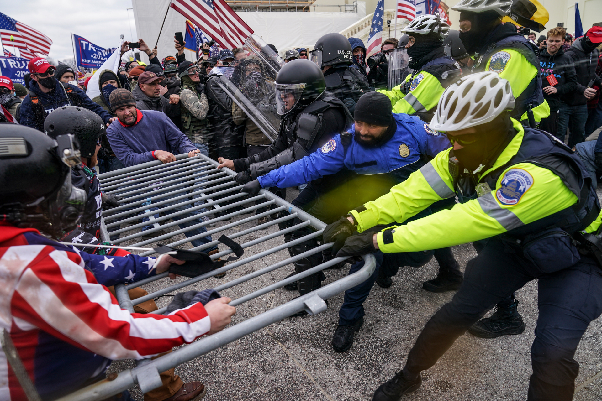 Rioters try to break through a police barrier at the Capitol in Washington DC yesterday. Photo / AP