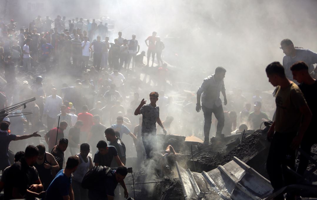 Palestinians inspect the rubble of destroyed buildings following Israeli airstrikes on the town of Khan Younis, southern Gaza Strip. Photo / AP